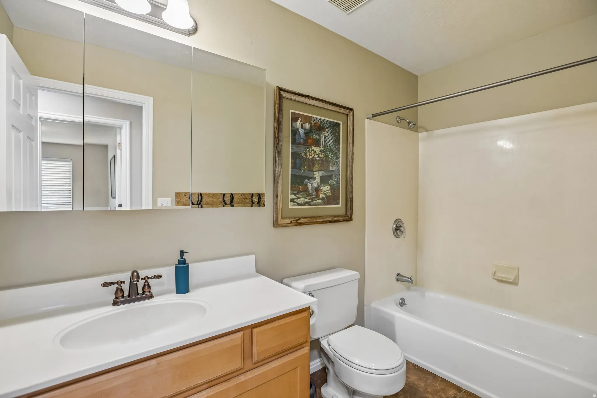 Full bath featuring vanity and shower / bathtub combination