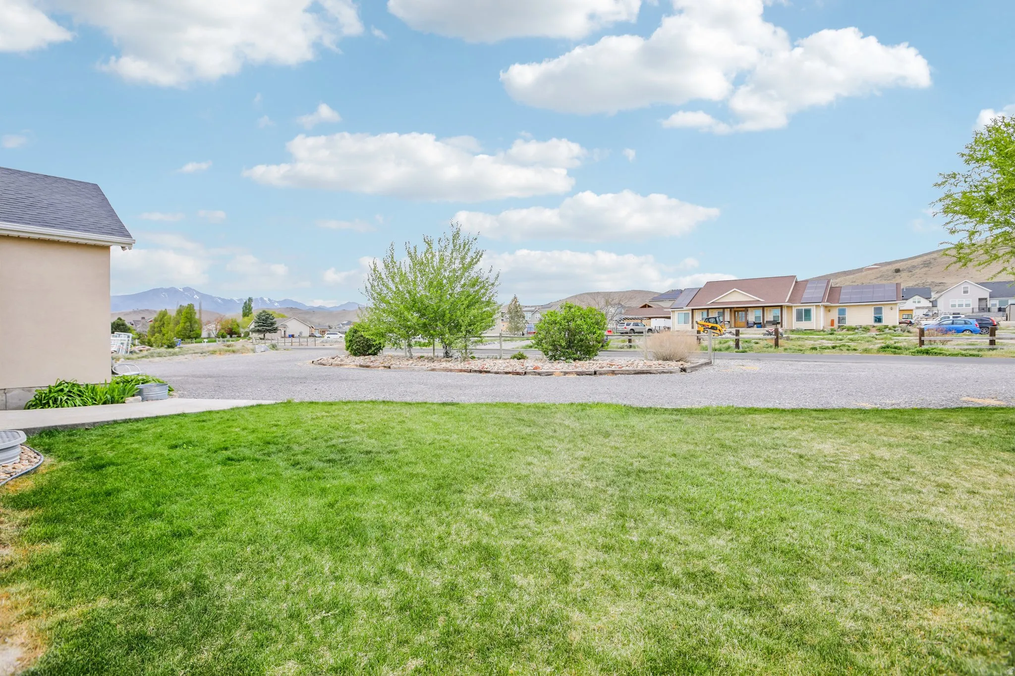 View of green lawn featuring a mountain view