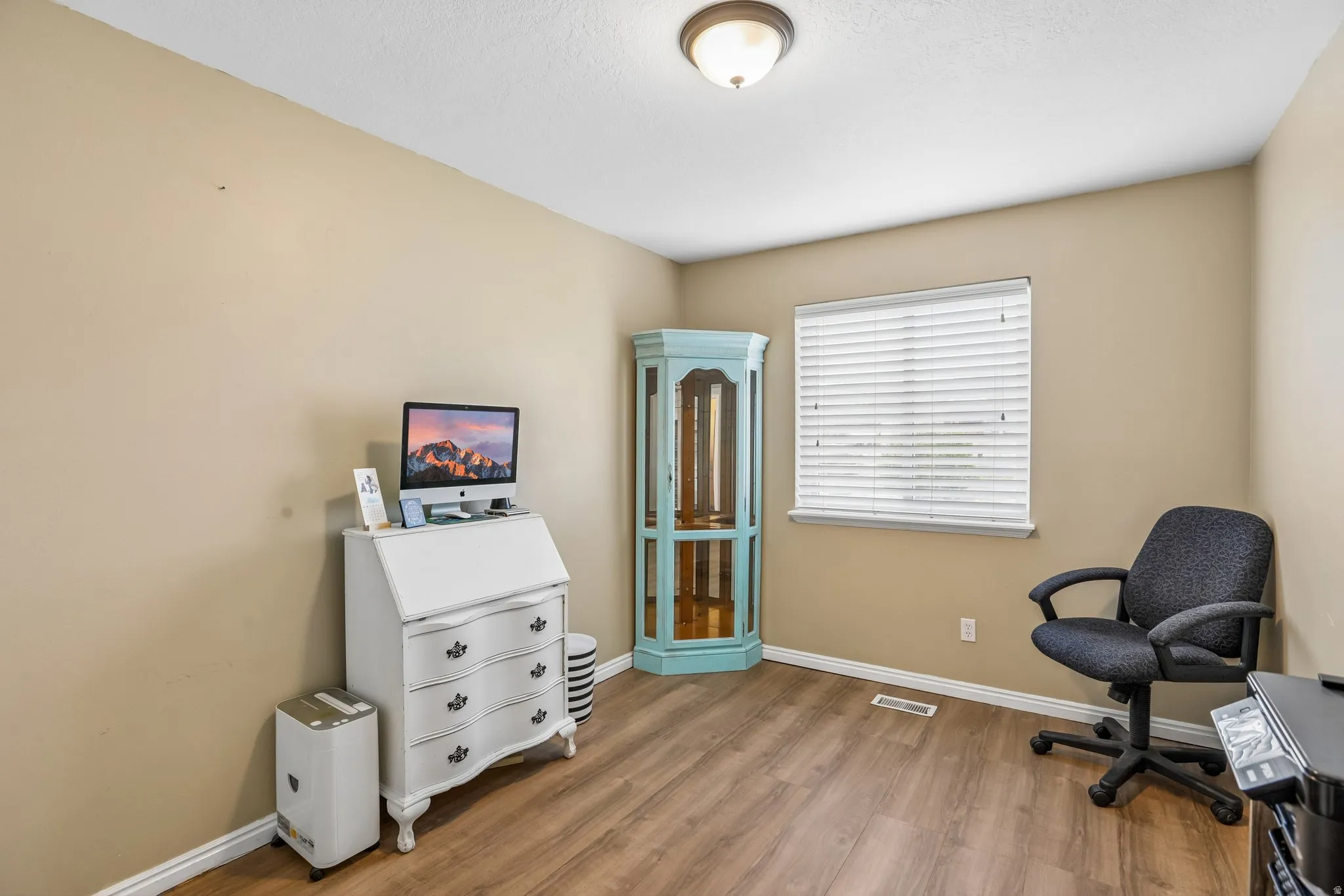 Home office with baseboards and light wood finished floors