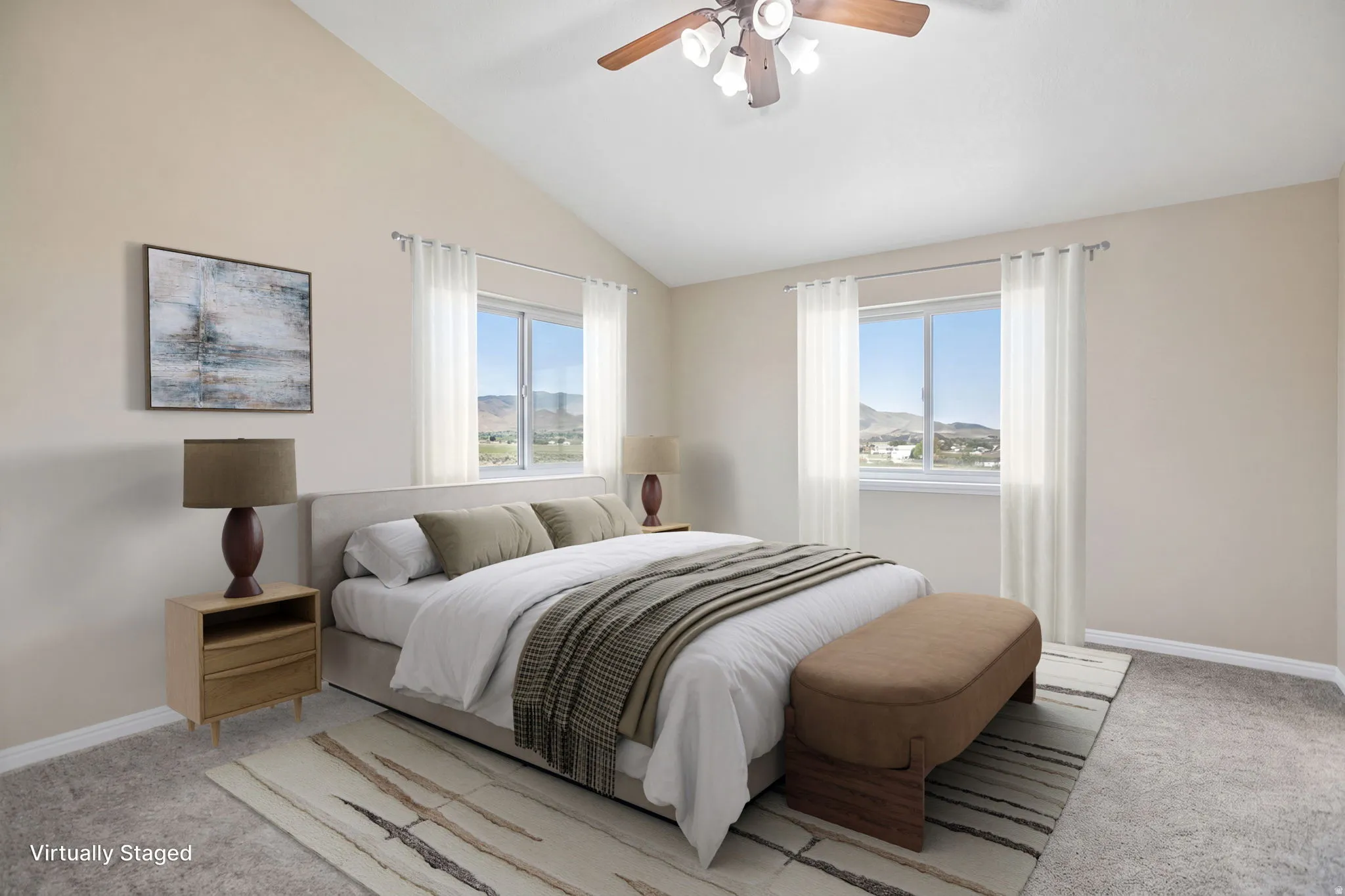 Primary bedroom virtually staged. Vaulted ceiling with a ceiling fan, dual windows, and light-colored carpeting