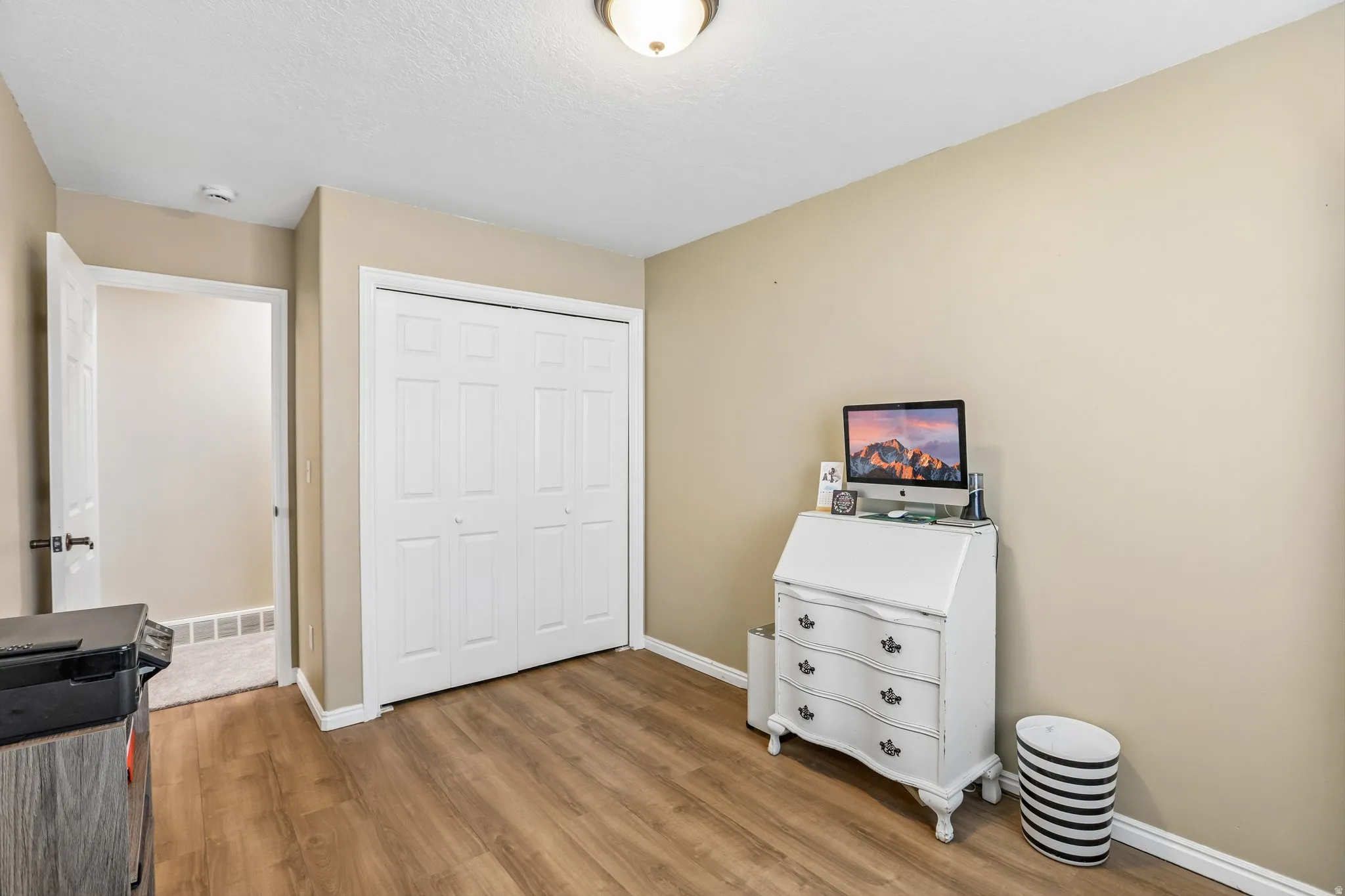 Bedroom with a closet and light wood-style floors