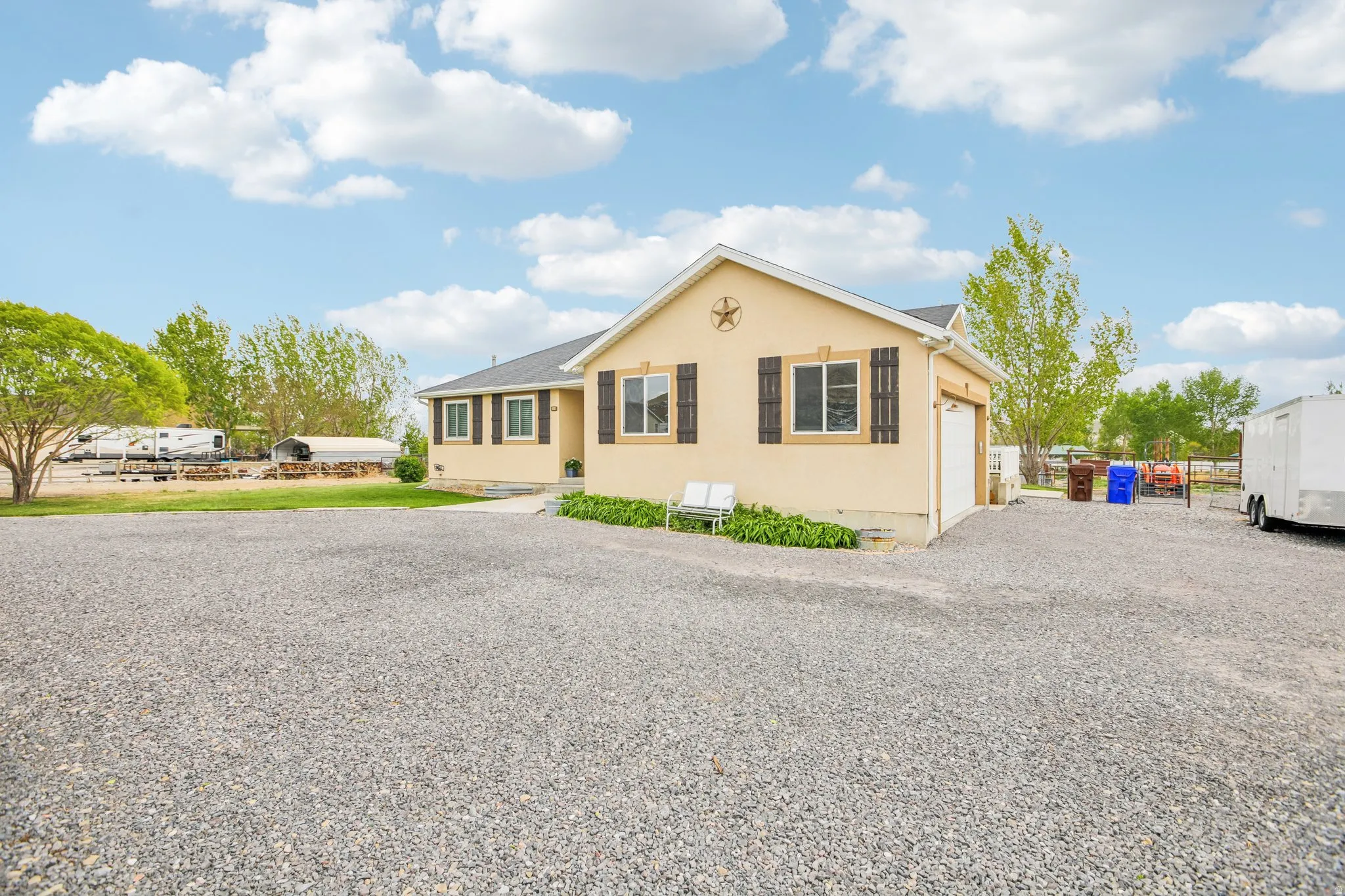 Ranch-style home with driveway, an attached garage, stucco