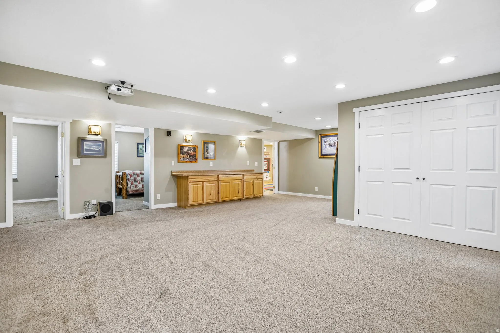 Unfurnished living room featuring light carpet and recessed lighting
