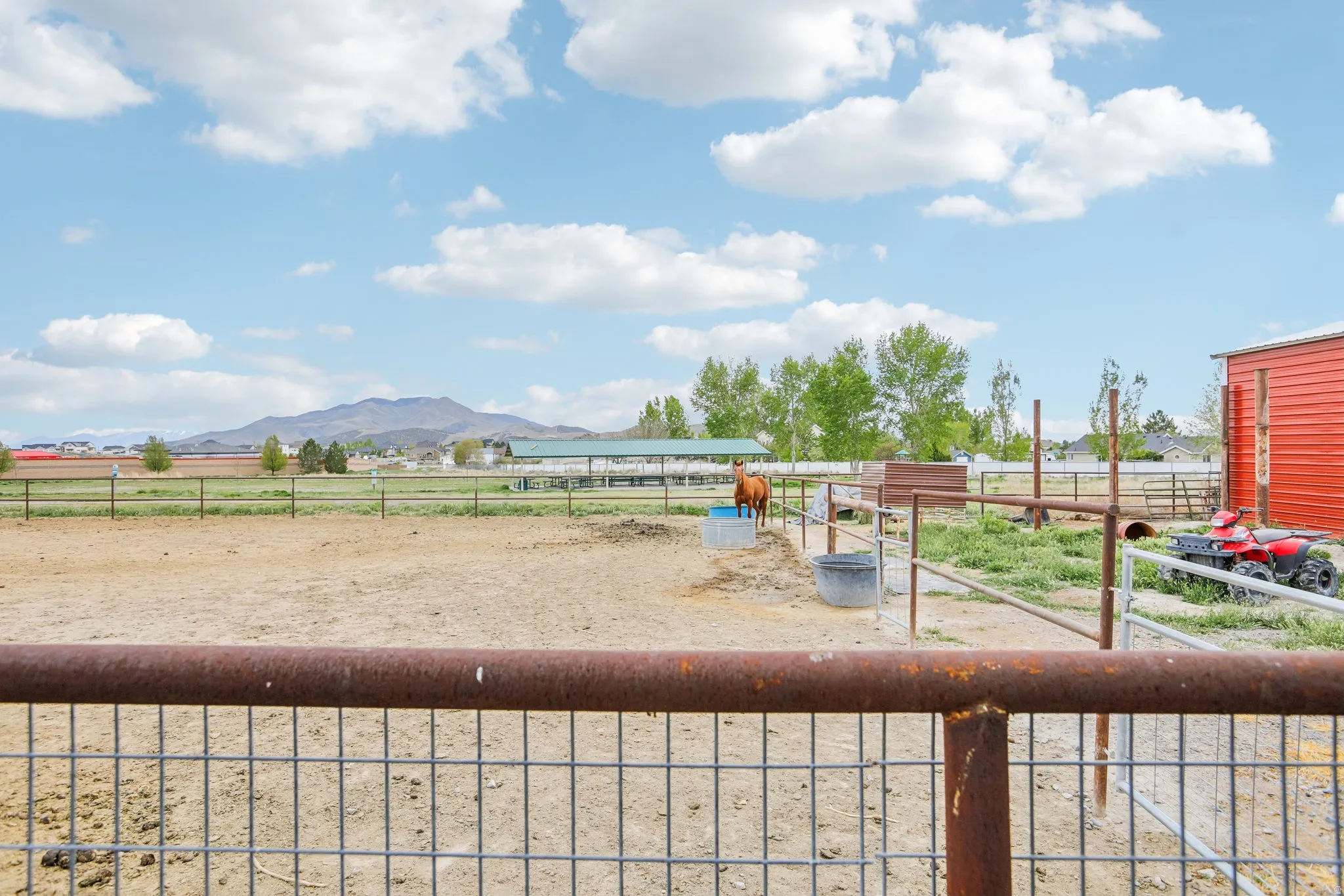 View of yard with a view of rural / pastoral area, an outbuilding, an exterior structure, and a mountain view