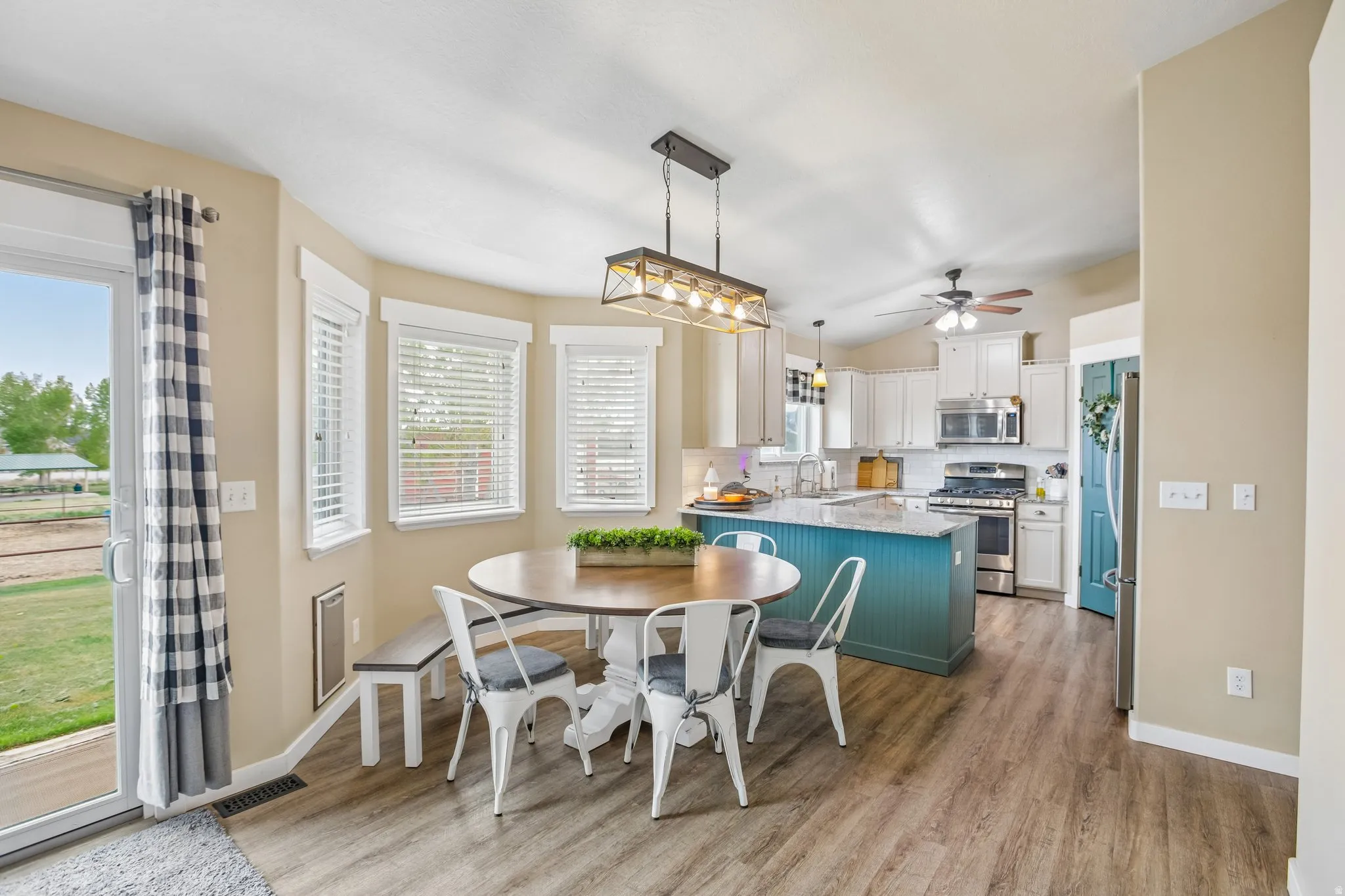 Dining space with light wood-style flooring and lofted ceiling