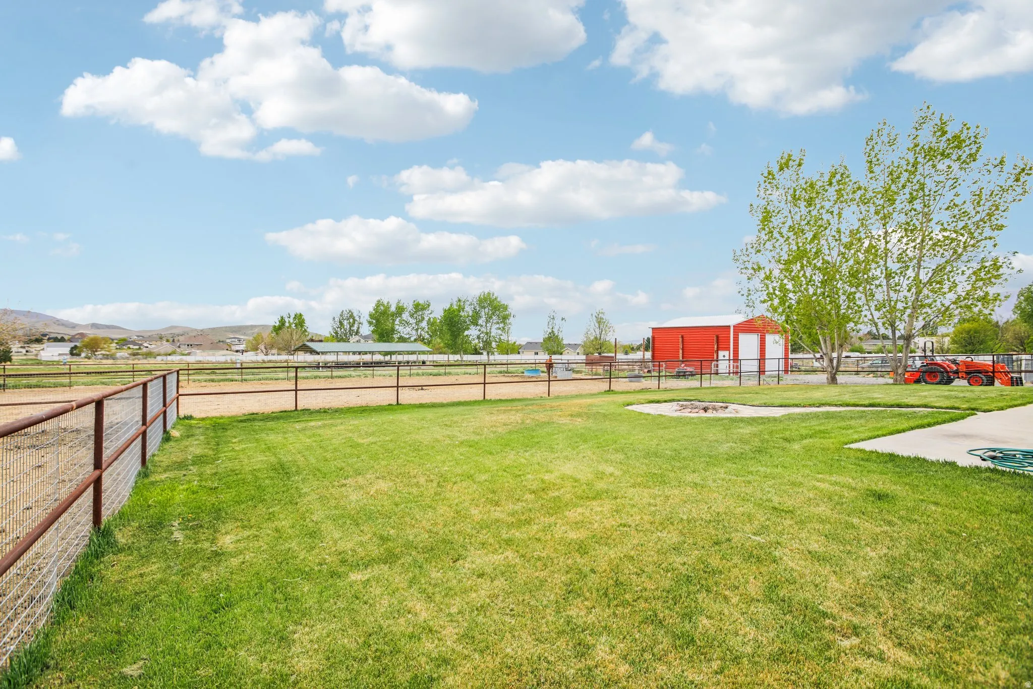 View of yard with a garage and an outbuilding