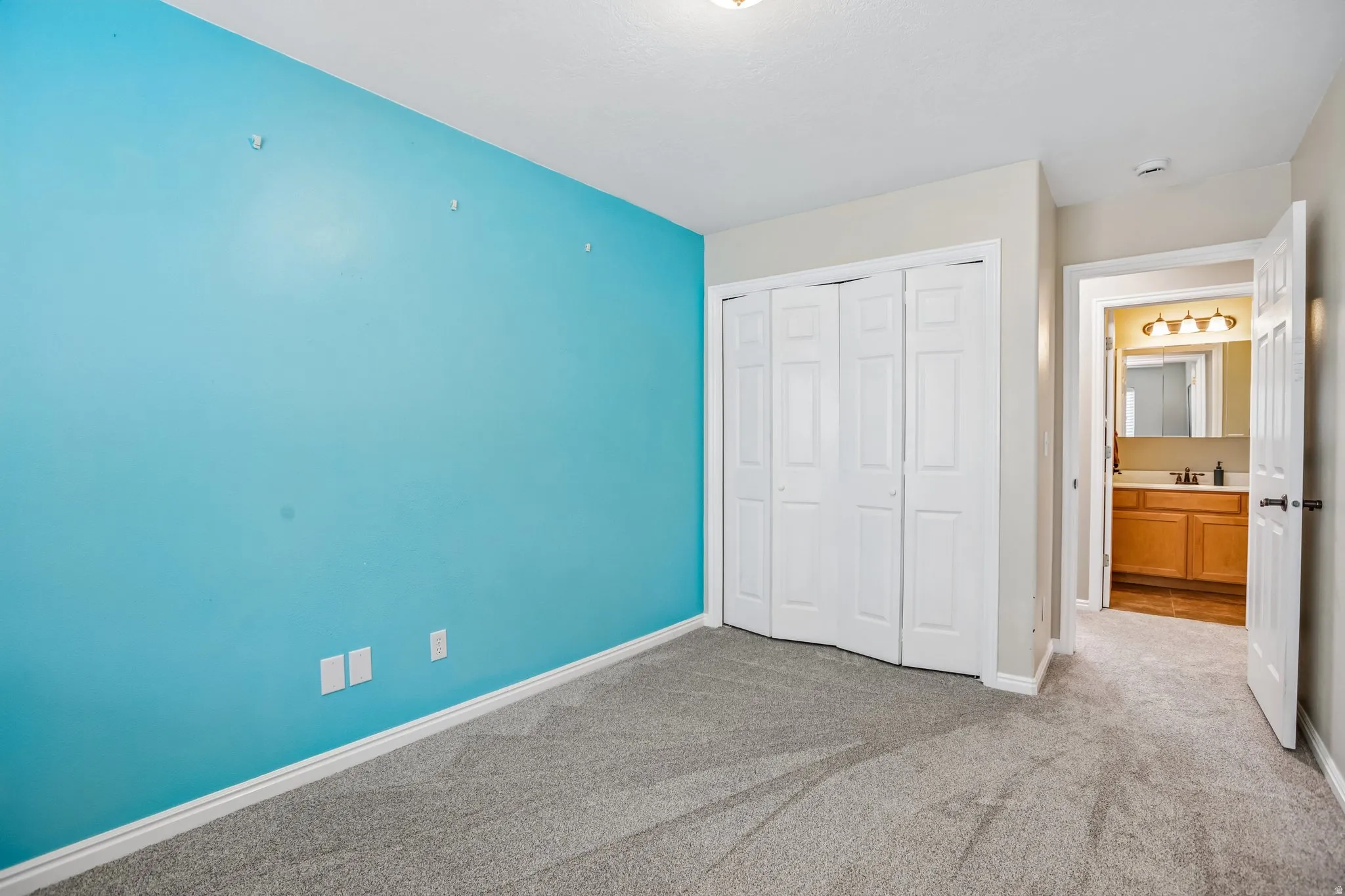 Unfurnished bedroom featuring carpet and a closet