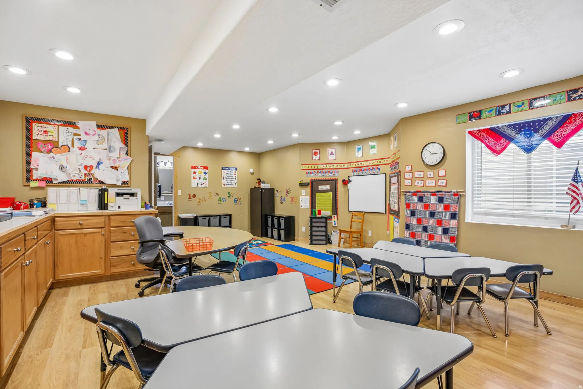 Rec room with light wood finished floors and recessed lighting