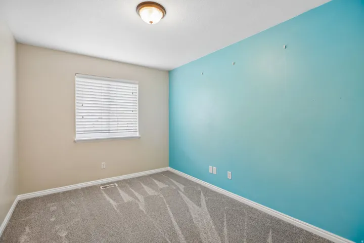 Carpeted empty room featuring baseboards