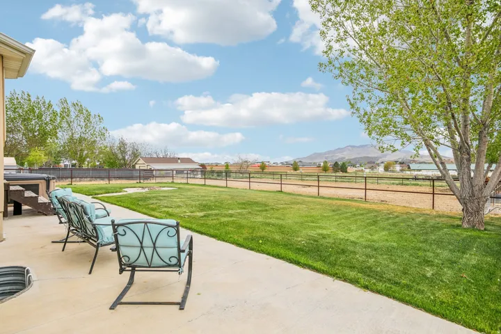Fenced backyard featuring a patio area and a mountain view