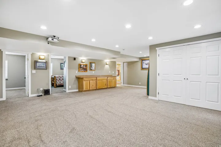Unfurnished living room featuring light carpet and recessed lighting