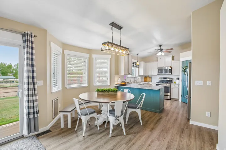 Dining space with light wood-style flooring and lofted ceiling