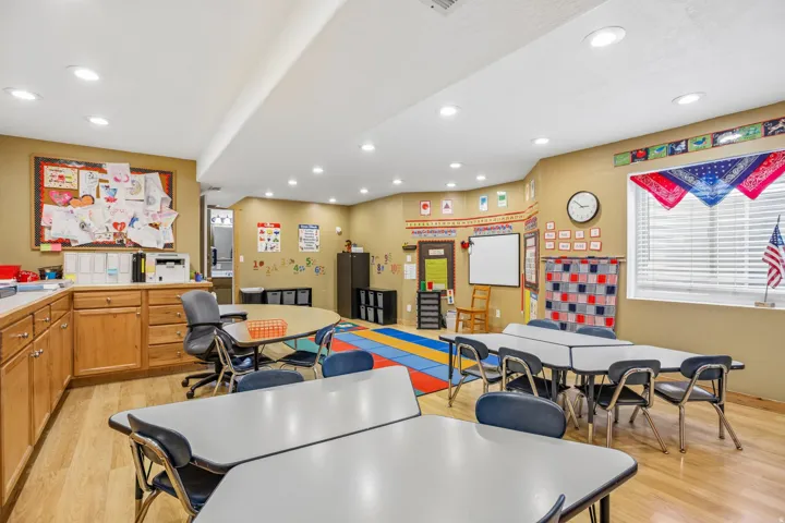 Rec room with light wood finished floors and recessed lighting