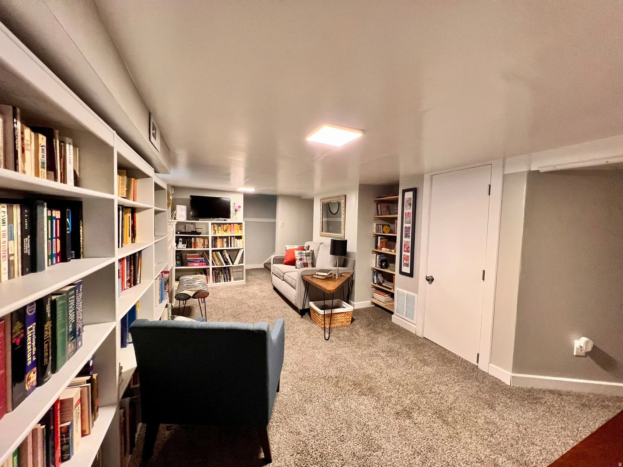 Sitting room featuring light colored carpet and baseboards