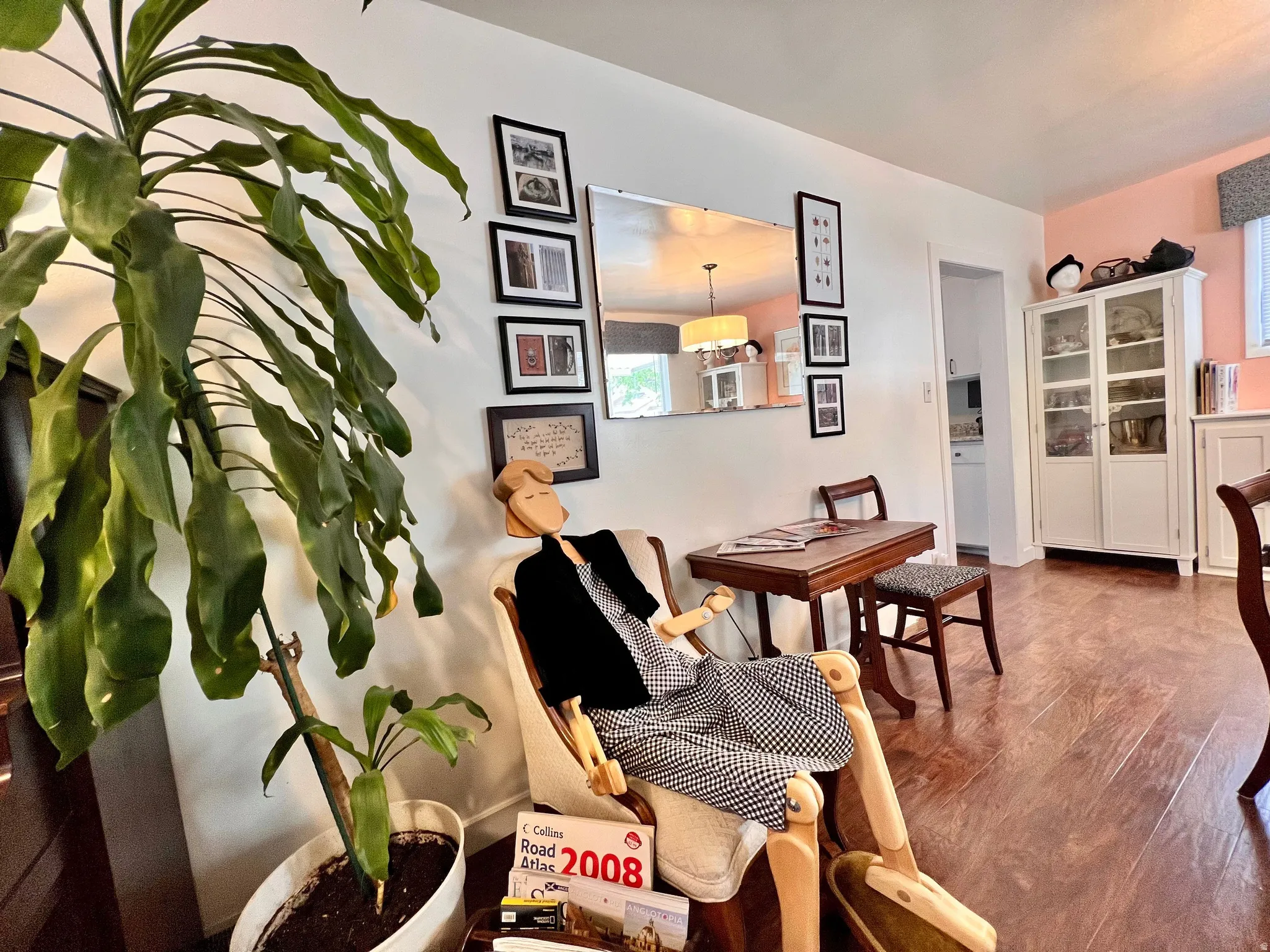 Dining space featuring dark wood-style flooring and baseboards