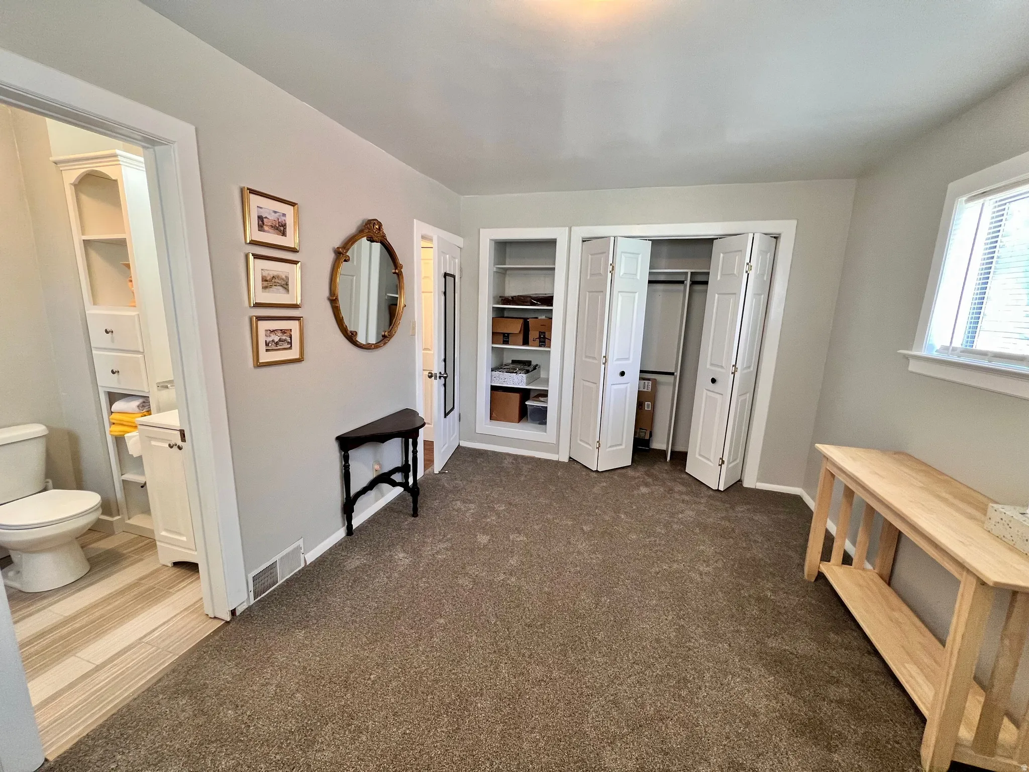 Bedroom featuring dark carpet, a closet, and connected bathroom