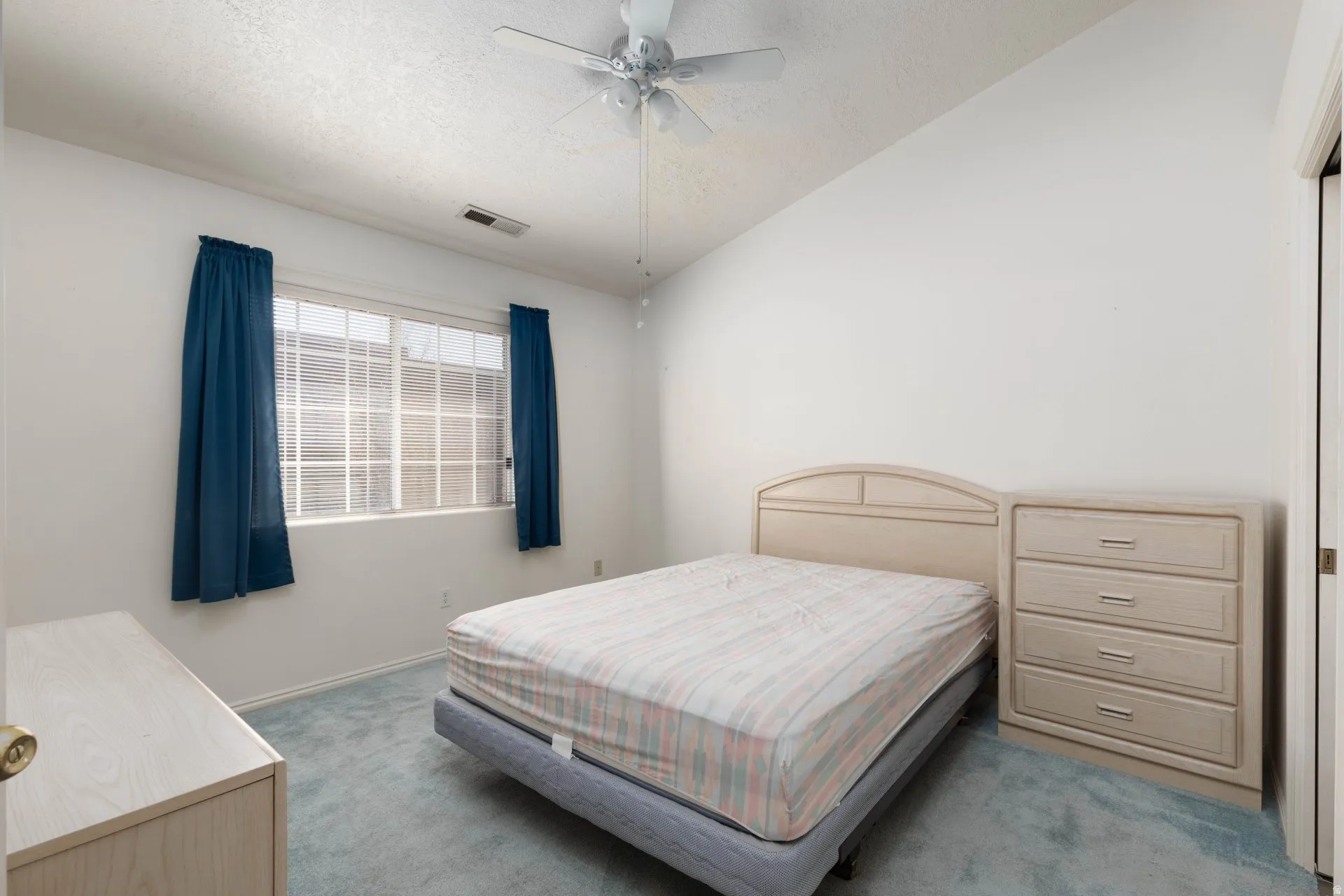 Bedroom featuring light colored carpet and a ceiling fan