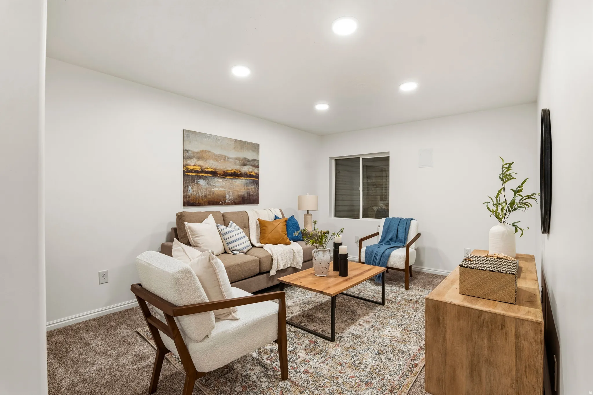 Carpeted living room featuring recessed lighting and baseboards