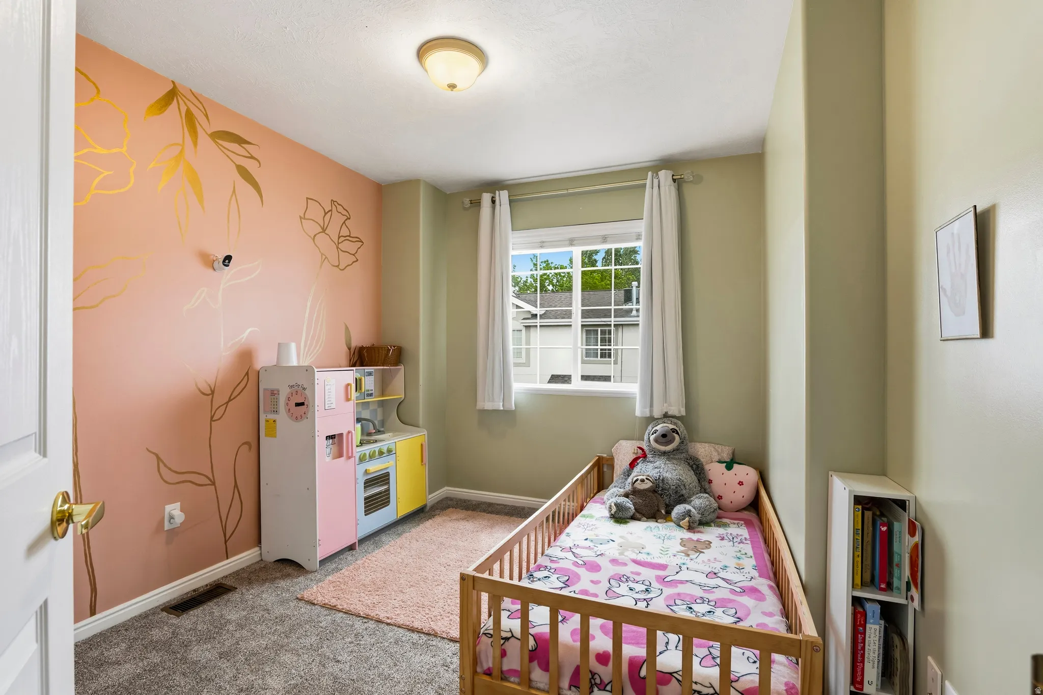 Bedroom featuring light carpet and baseboards