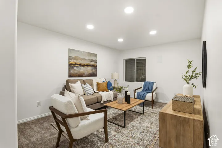 Carpeted living room featuring recessed lighting and baseboards