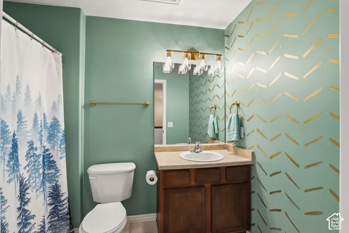 Bathroom with vanity and curtained shower