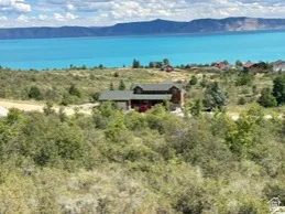 View from above of property with a water and mountain view