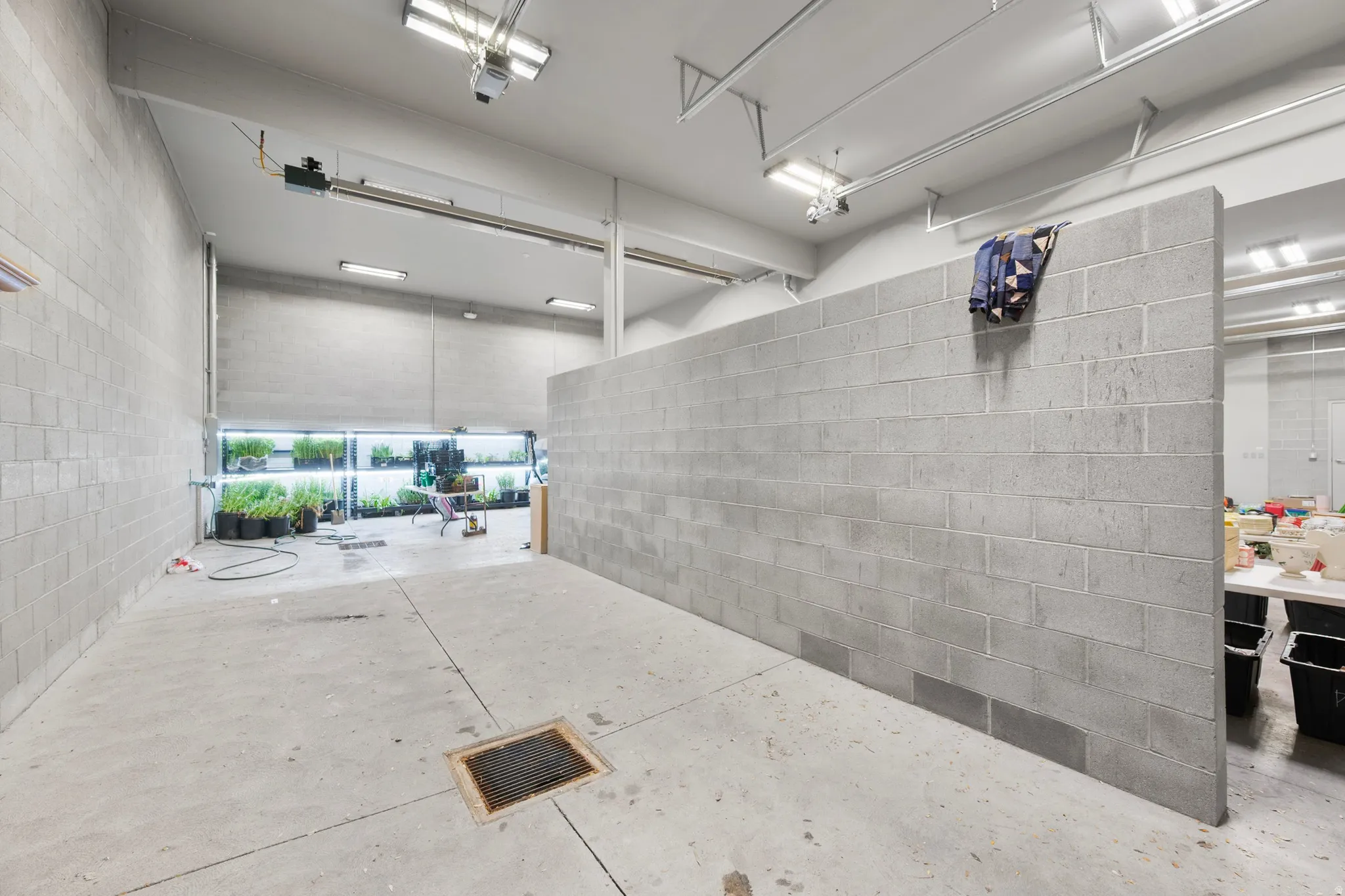 Garage featuring concrete block wall and a garage door opener