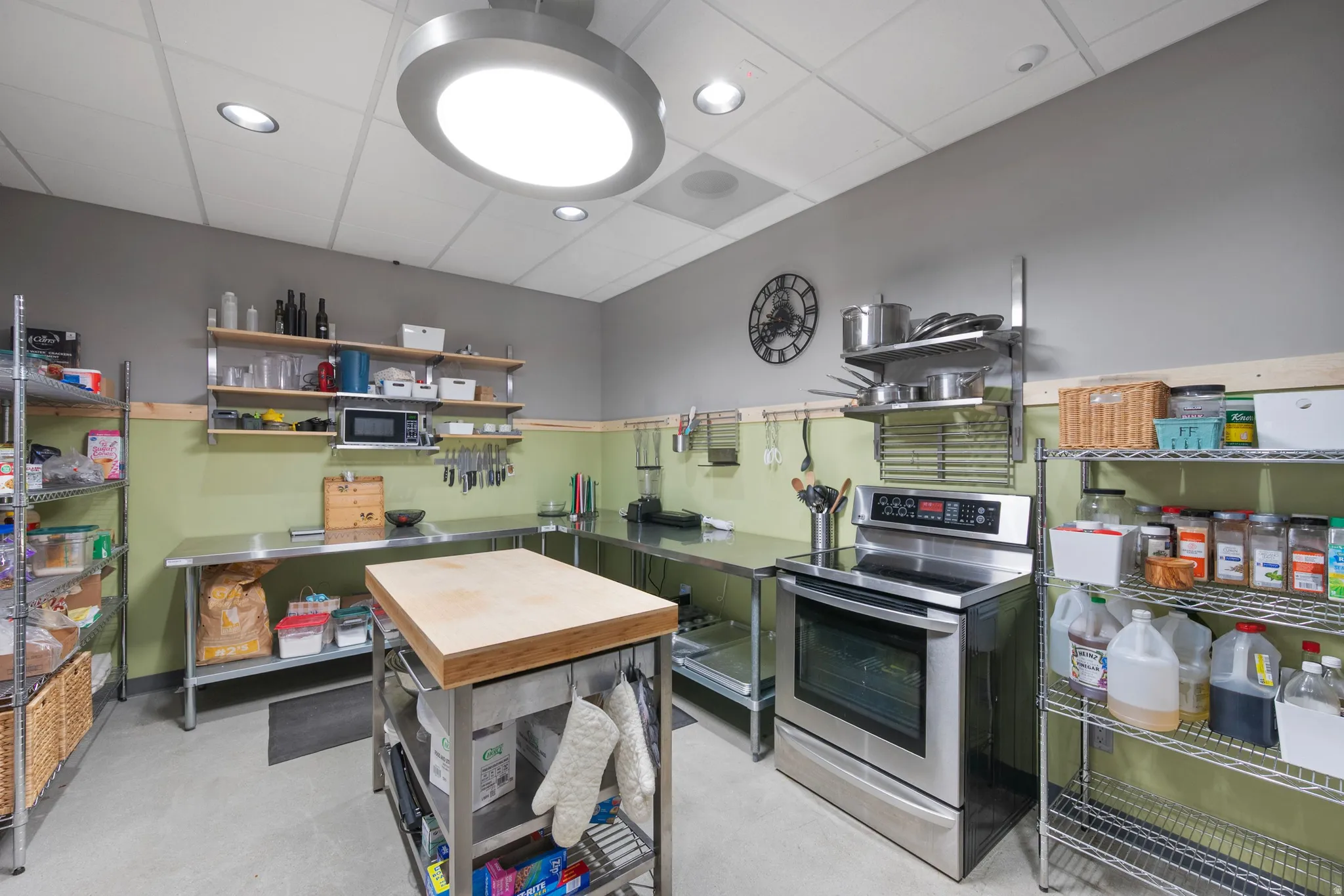Kitchen with stainless steel appliances, a paneled ceiling, and recessed lighting