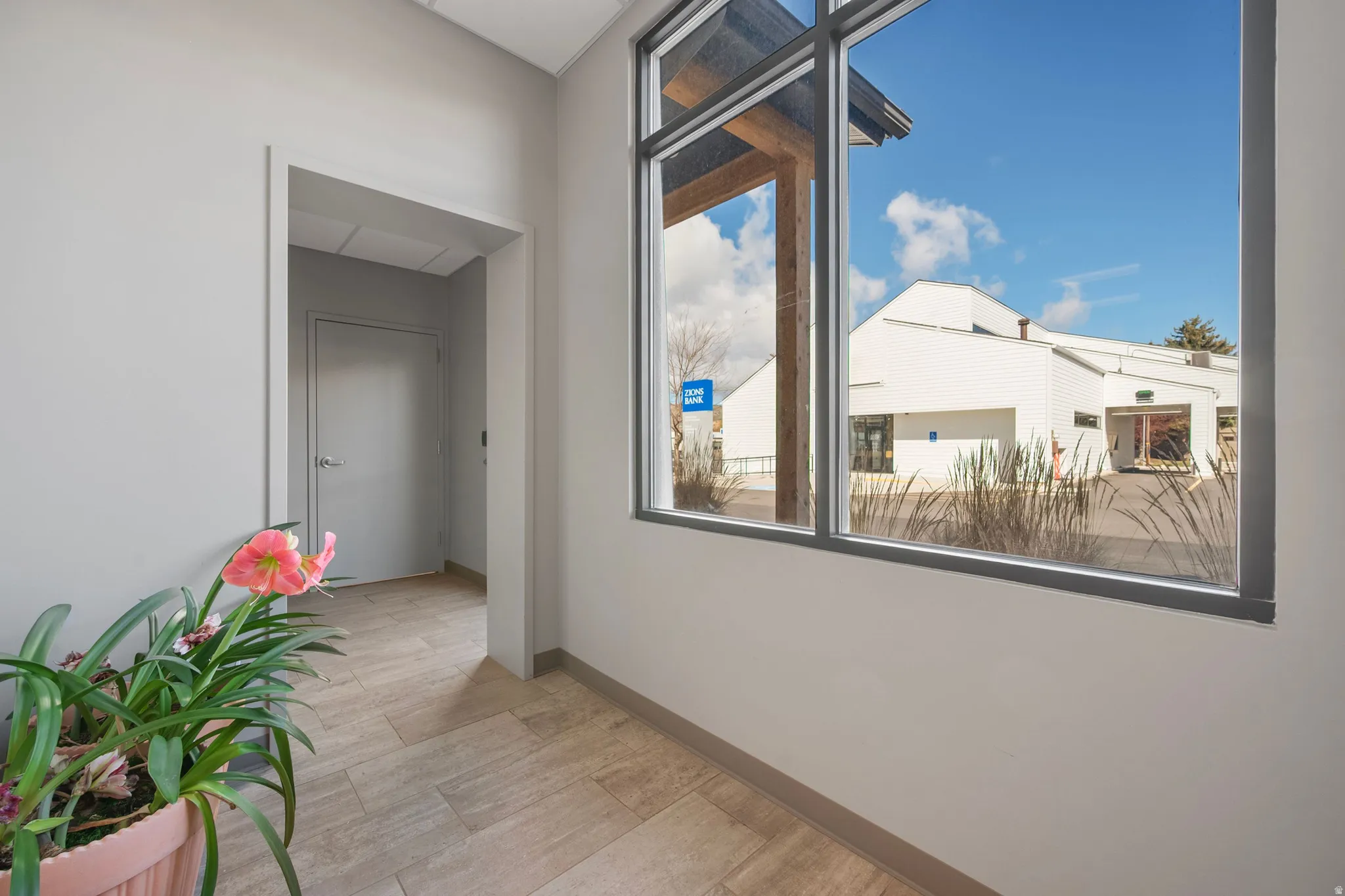 Corridor featuring baseboards and light wood-style floors