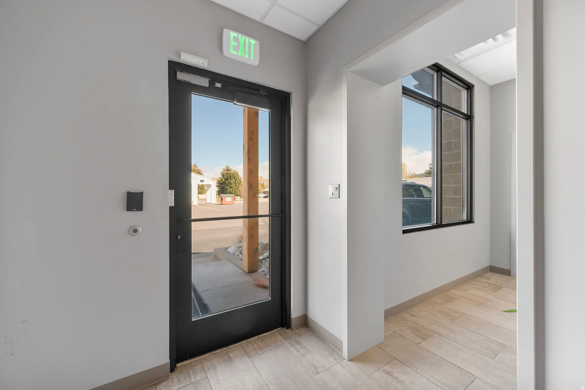 Foyer entrance with light wood finished floors and healthy amount of natural light