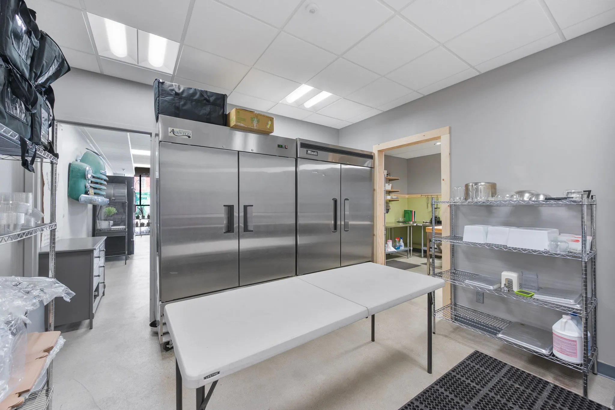 Kitchen featuring a drop ceiling and high quality fridge
