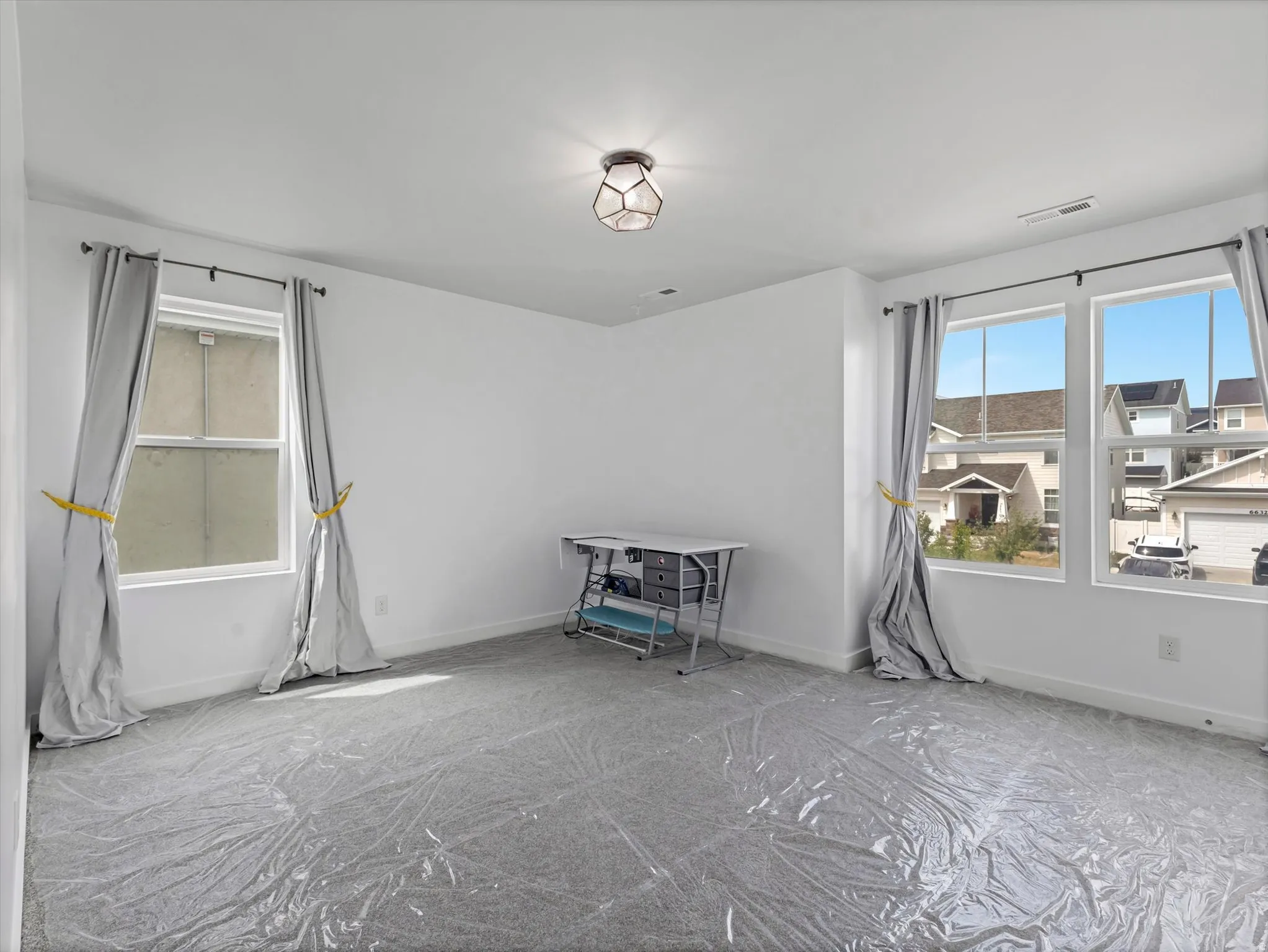 Spare room with carpet and baseboards