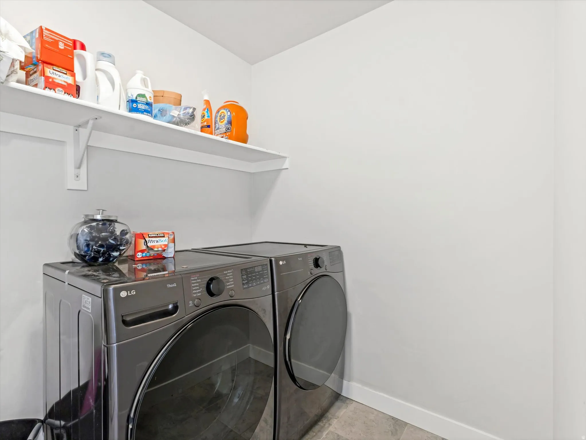 Laundry area featuring baseboards and washing machine and dryer