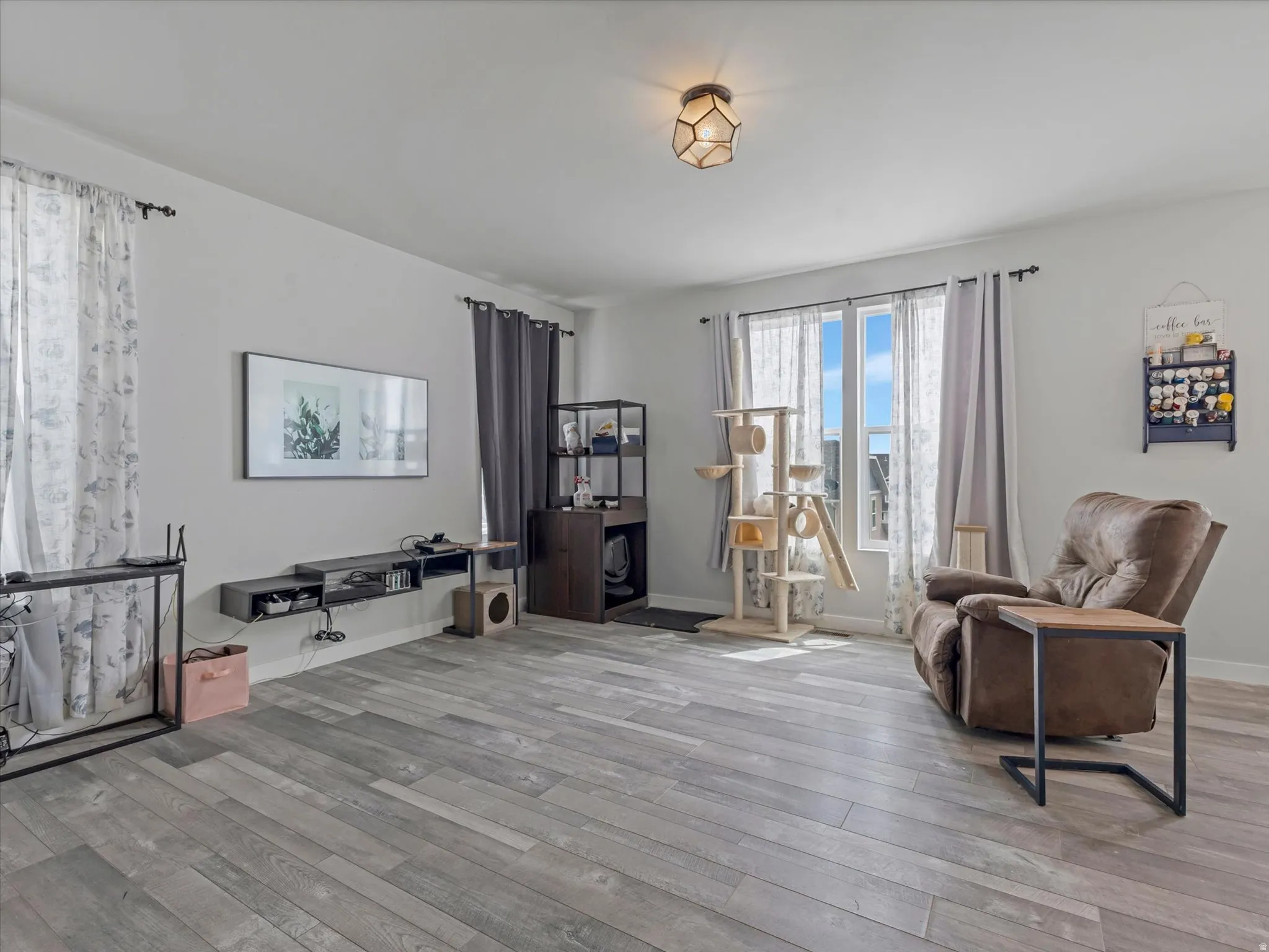 Living area featuring light wood-style floors and baseboards