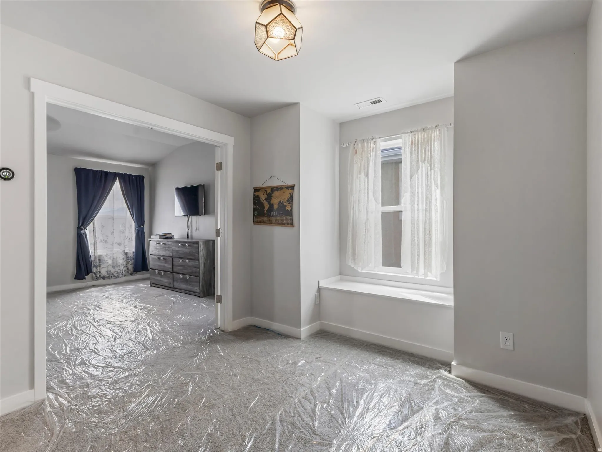 Unfurnished bedroom featuring baseboards and carpet