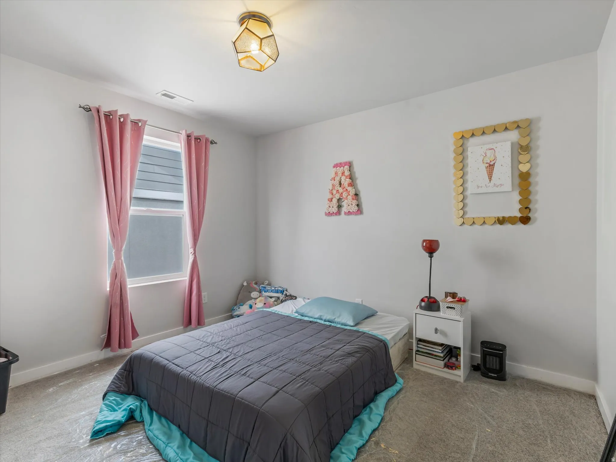 Bedroom featuring baseboards and carpet floors