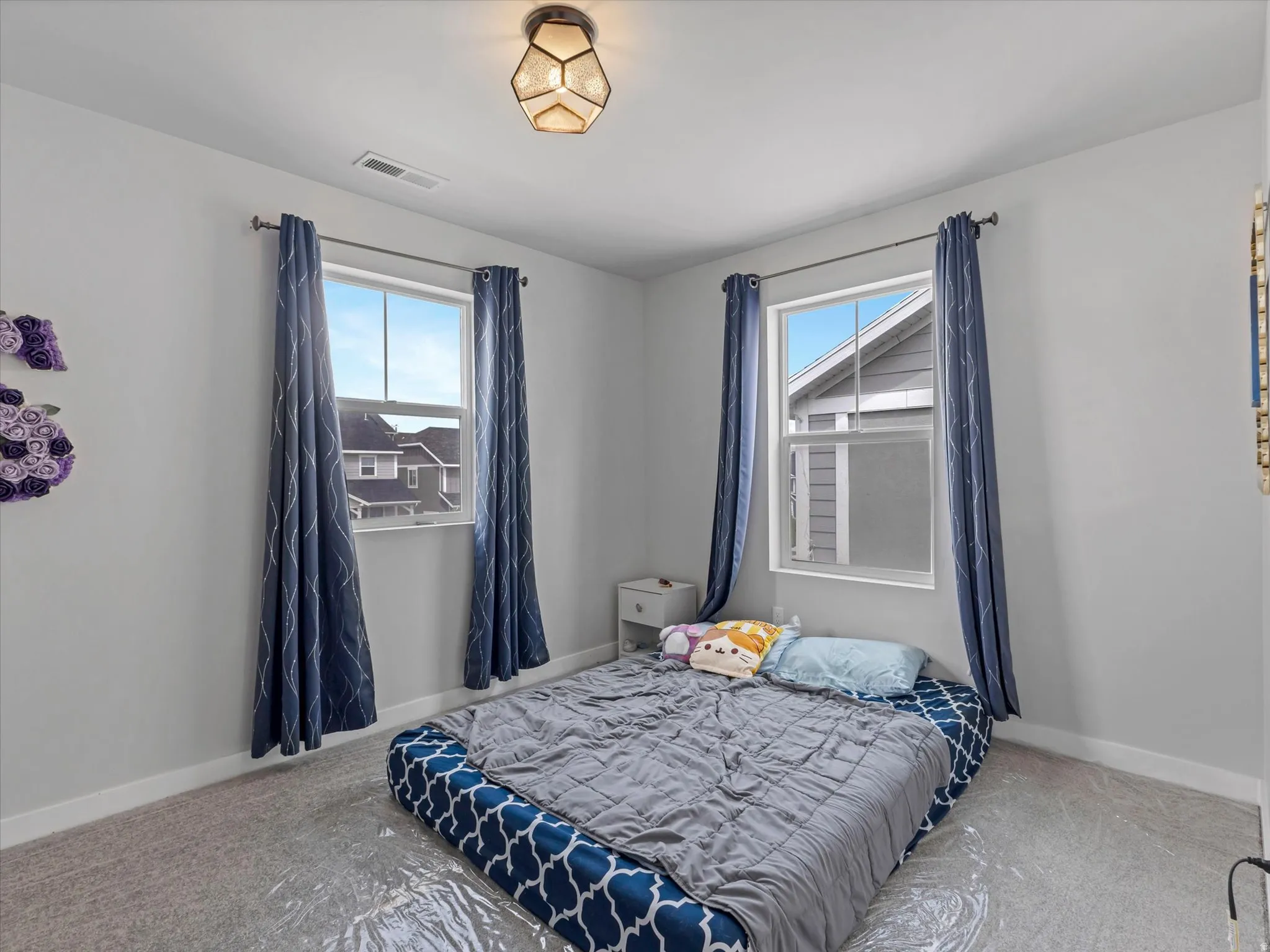 Carpeted bedroom featuring baseboards