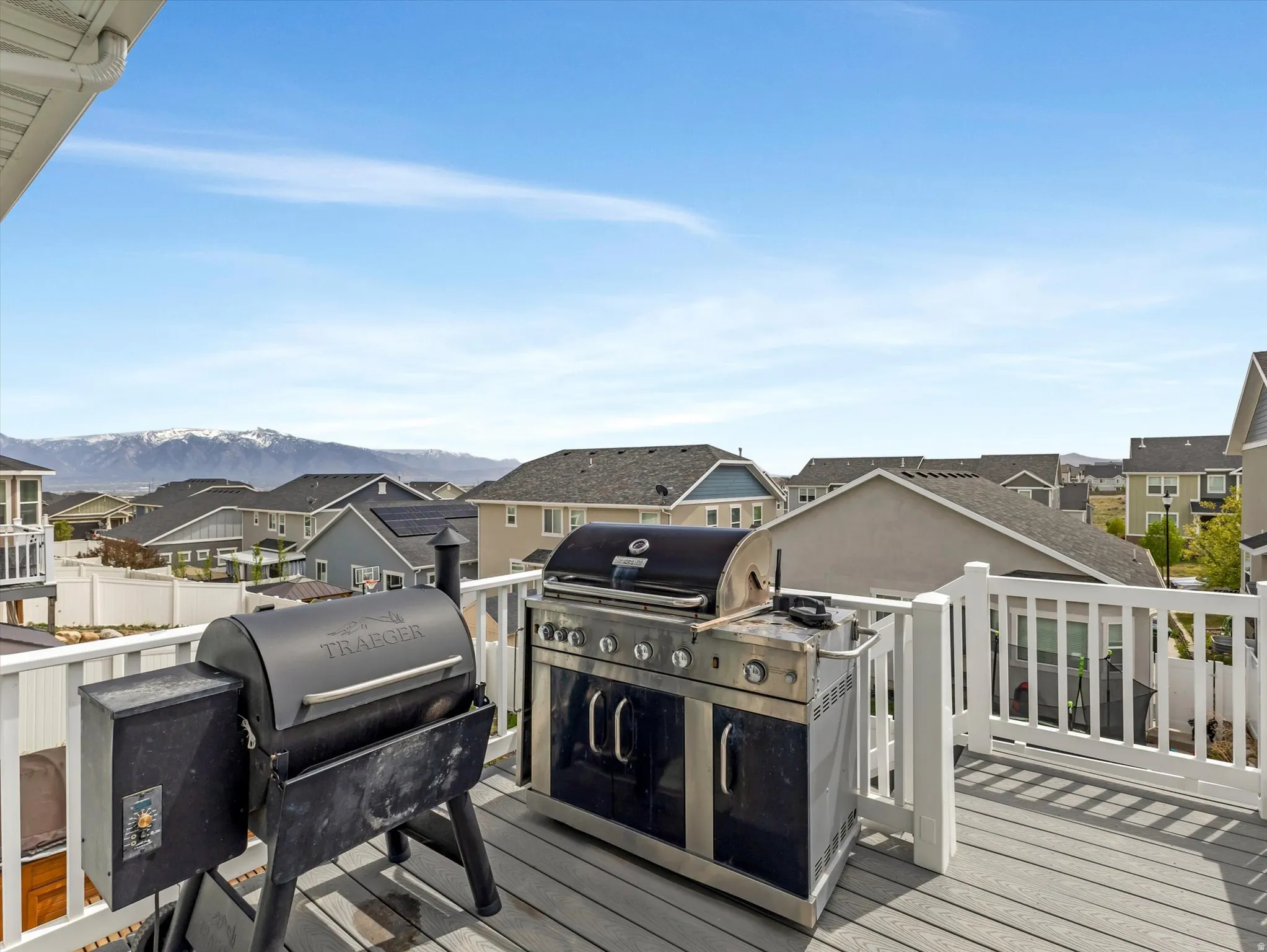 Deck with grilling area and a residential view