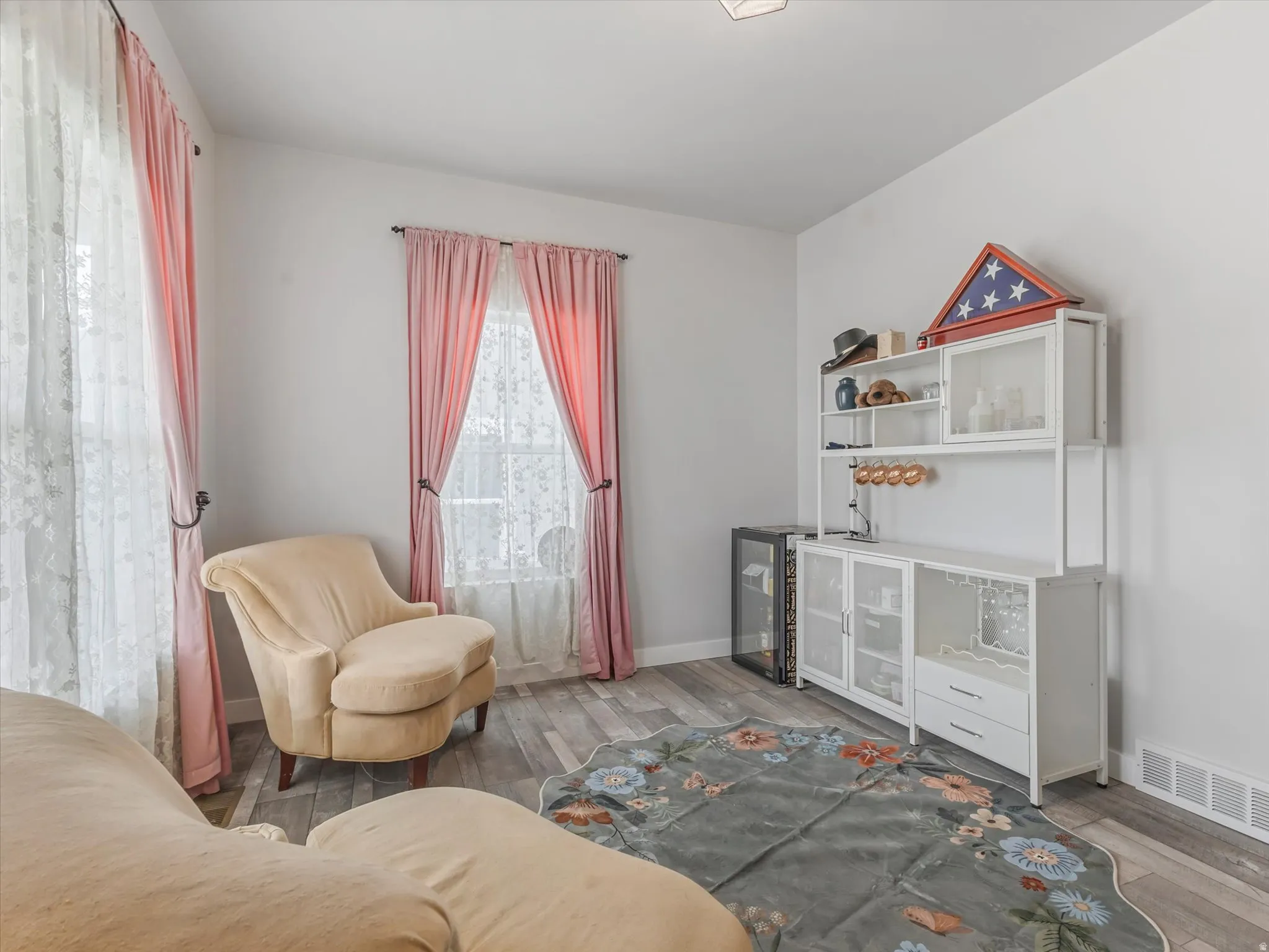 Living area featuring wood finished floors and beverage cooler