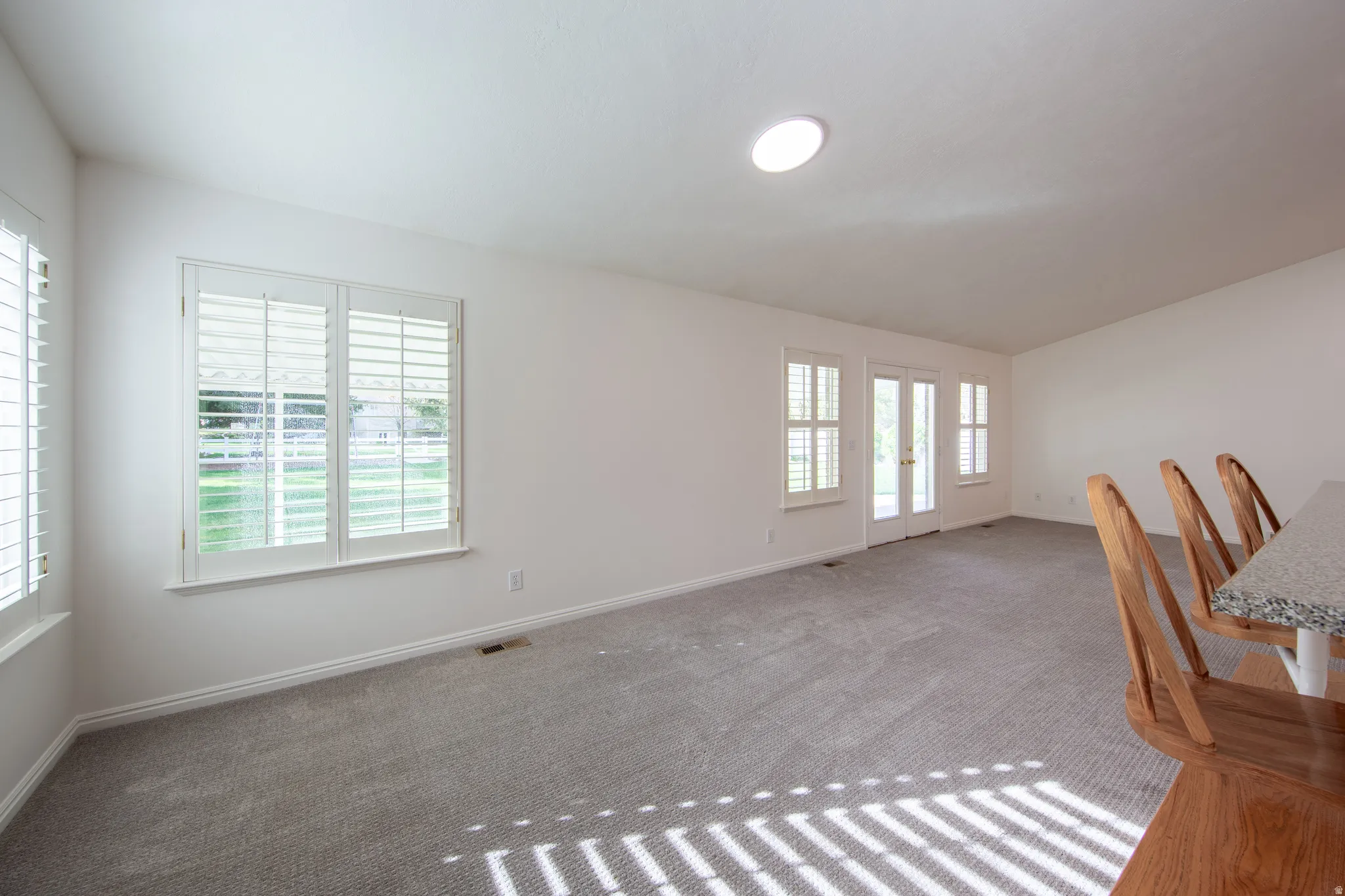 Unfurnished room with carpet flooring and french doors