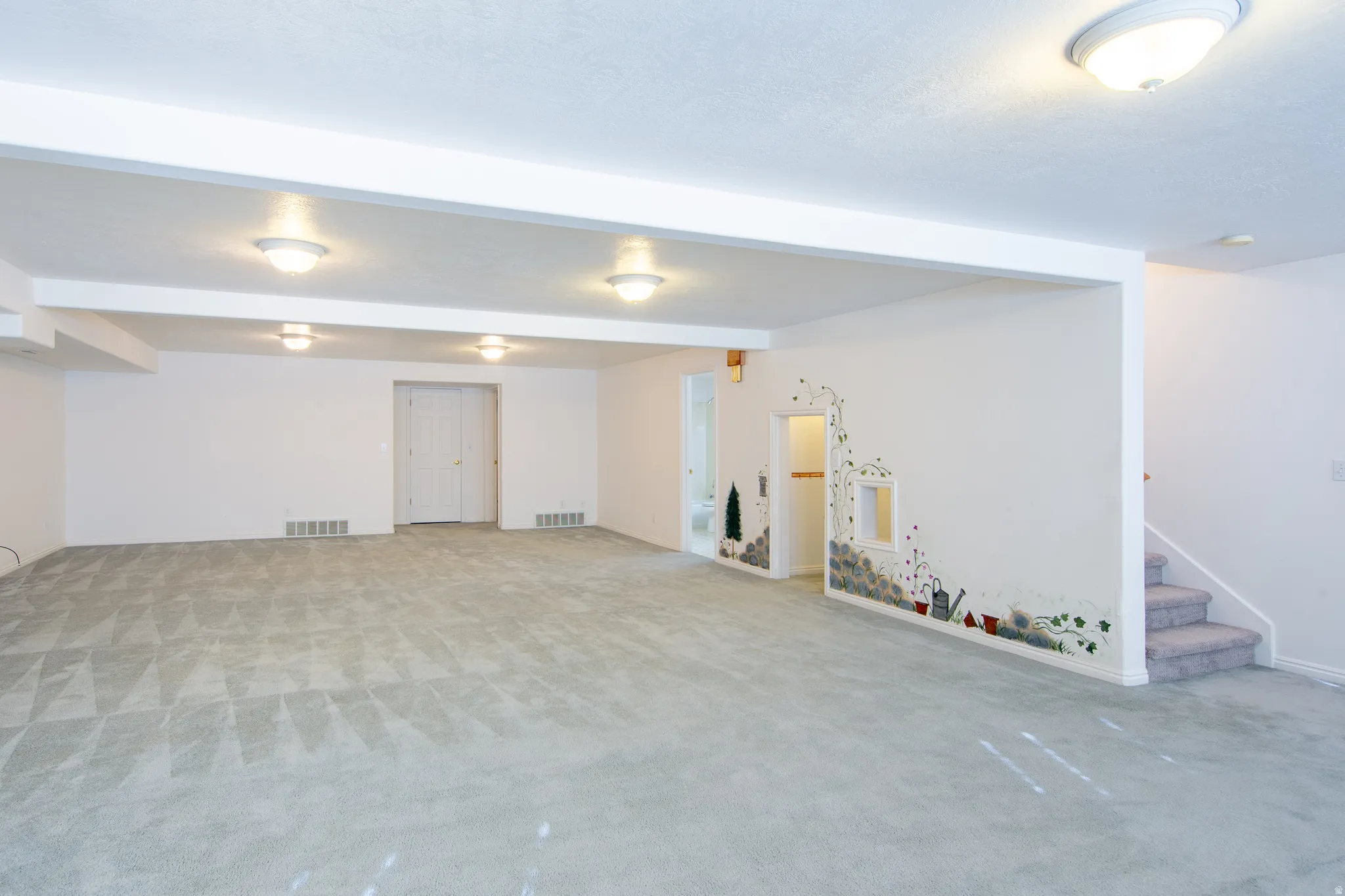 Finished basement featuring light carpet
