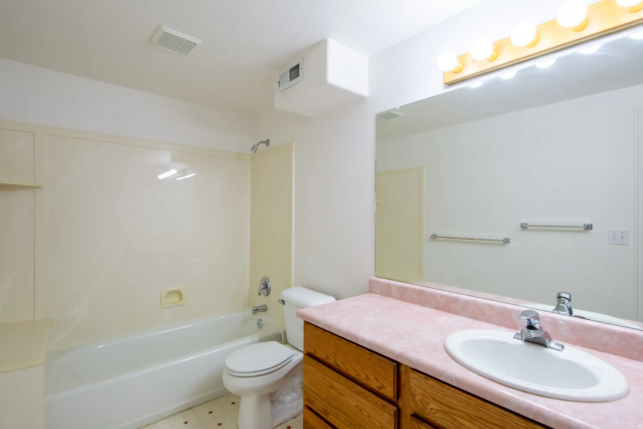 Bathroom with vanity and tub / shower combination