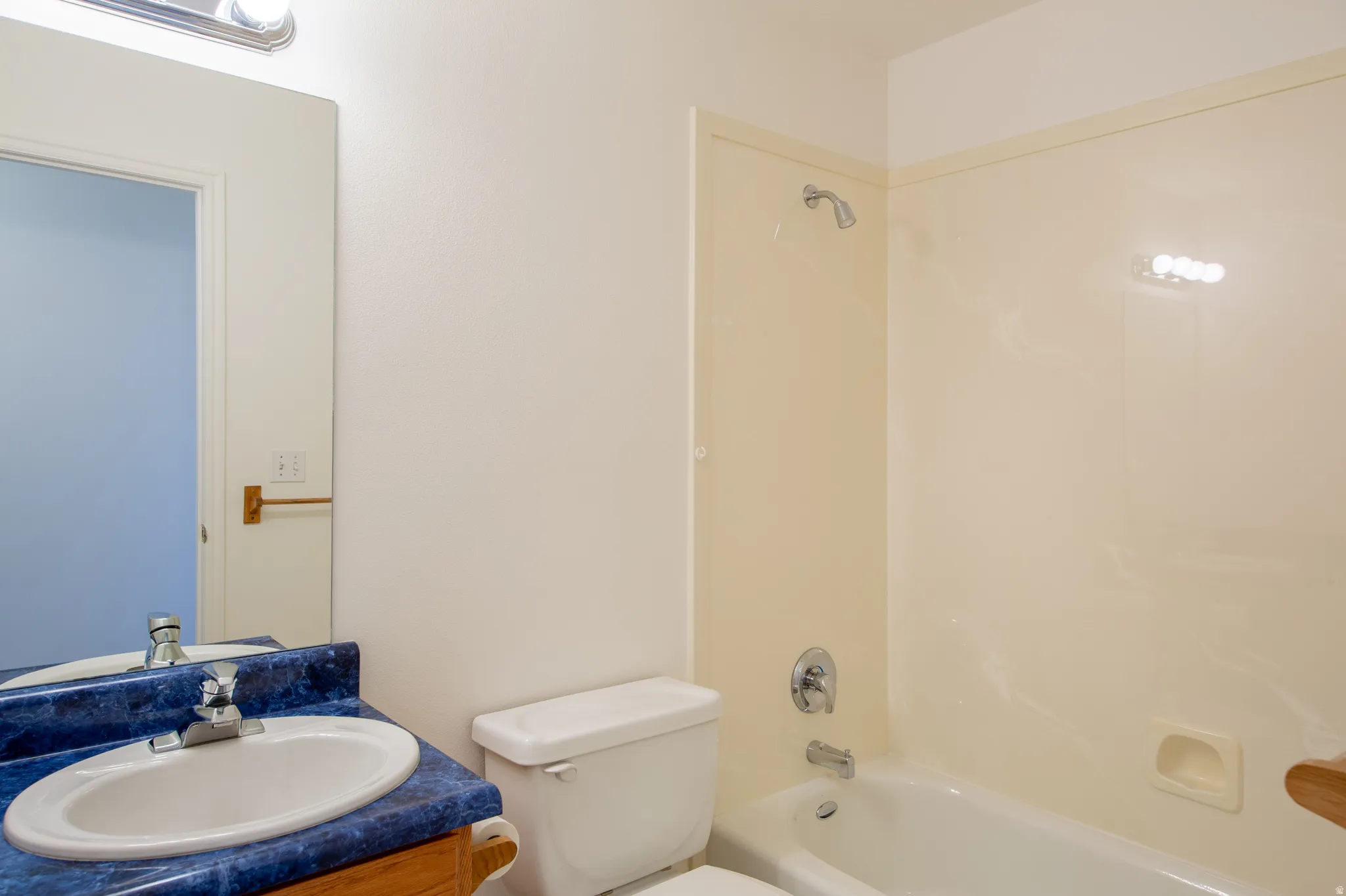 Full bath with vanity and shower / bath combination