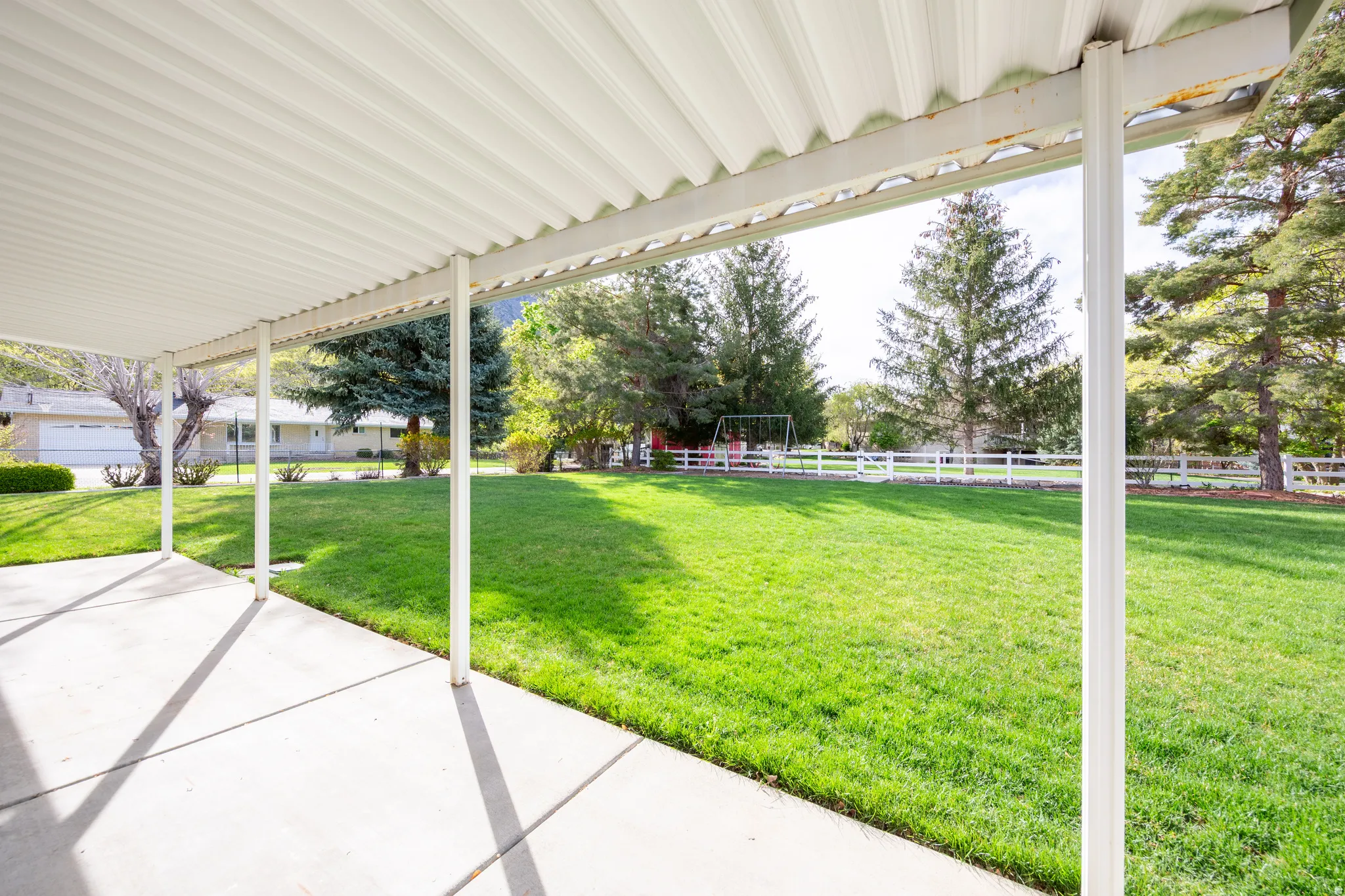 Fenced backyard with a patio