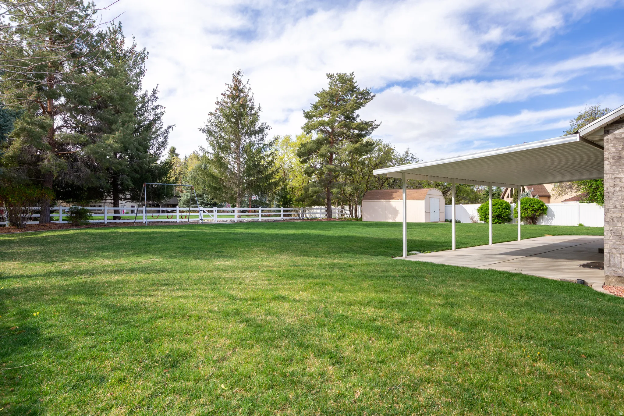 Fenced yard with a storage shed