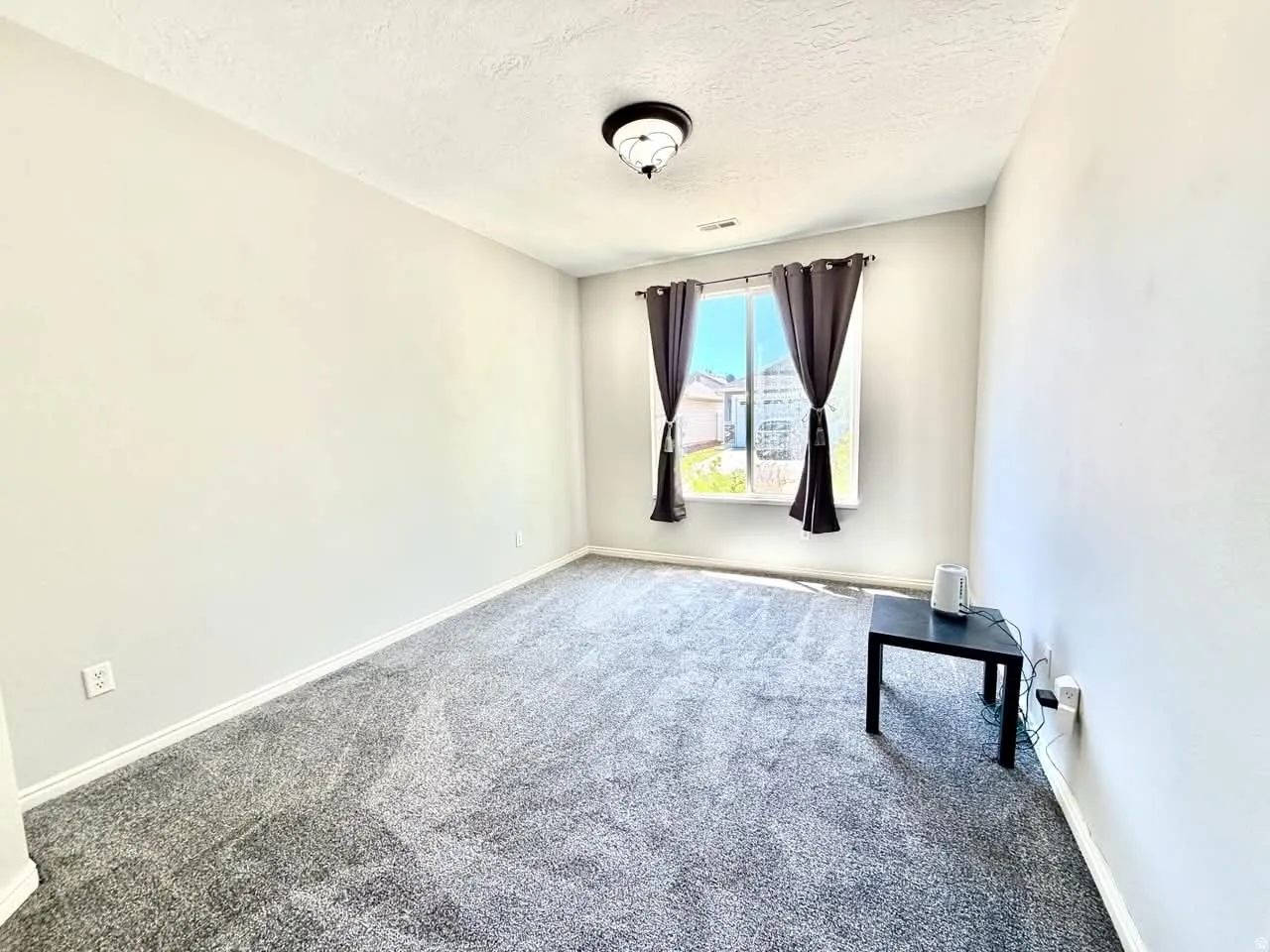 Neutral-toned walls complement the gray carpeting