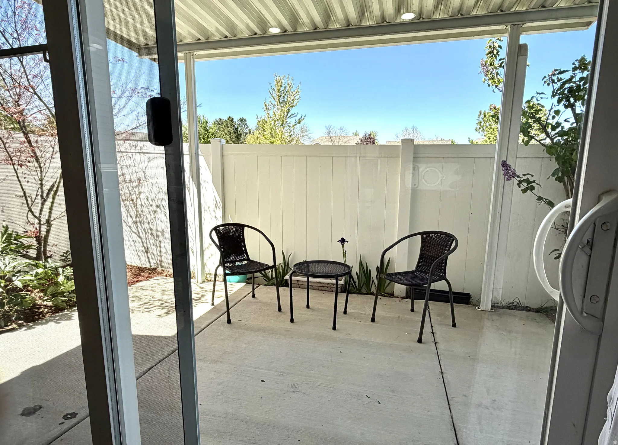 Private concrete patio with a full-length patio cover