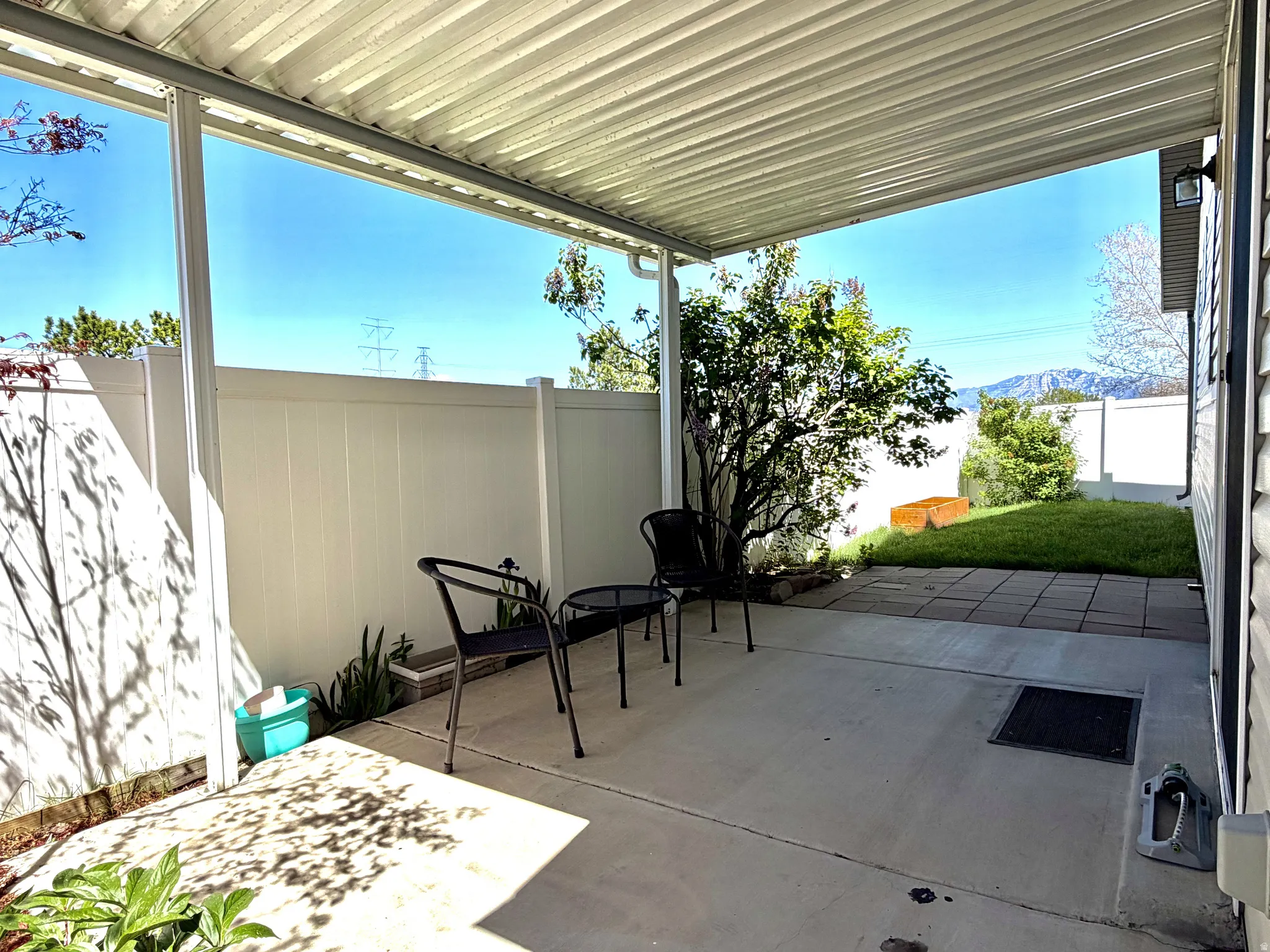 Covered patio featuring a concrete slab and a white slatted roof
