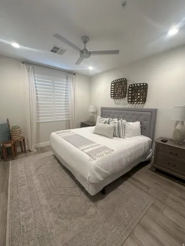 Bedroom featuring light wood-type flooring, ceiling fan, and recessed lighting