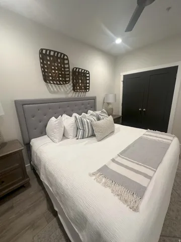 Bedroom featuring a closet, ceiling fan, and wood finished floors